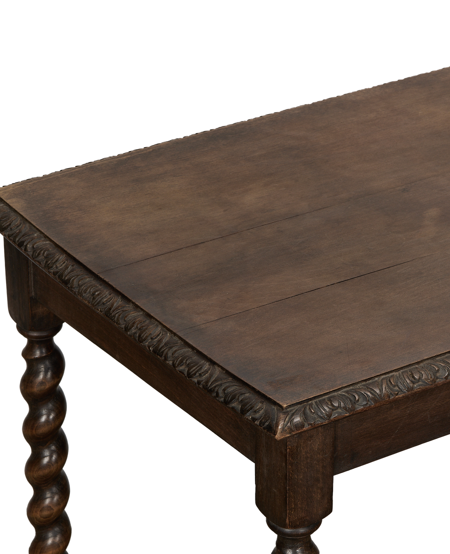 Vintage oak entry table close-up showing carved apron detail, barley twist legs.