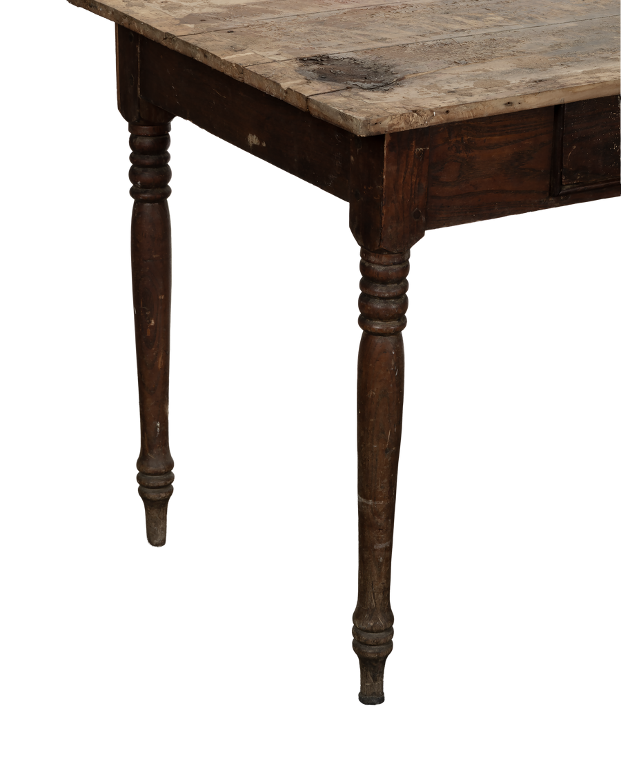 Vintage oak farm table from France, showing ornate turned legs and distressed tabletop from an angle.
