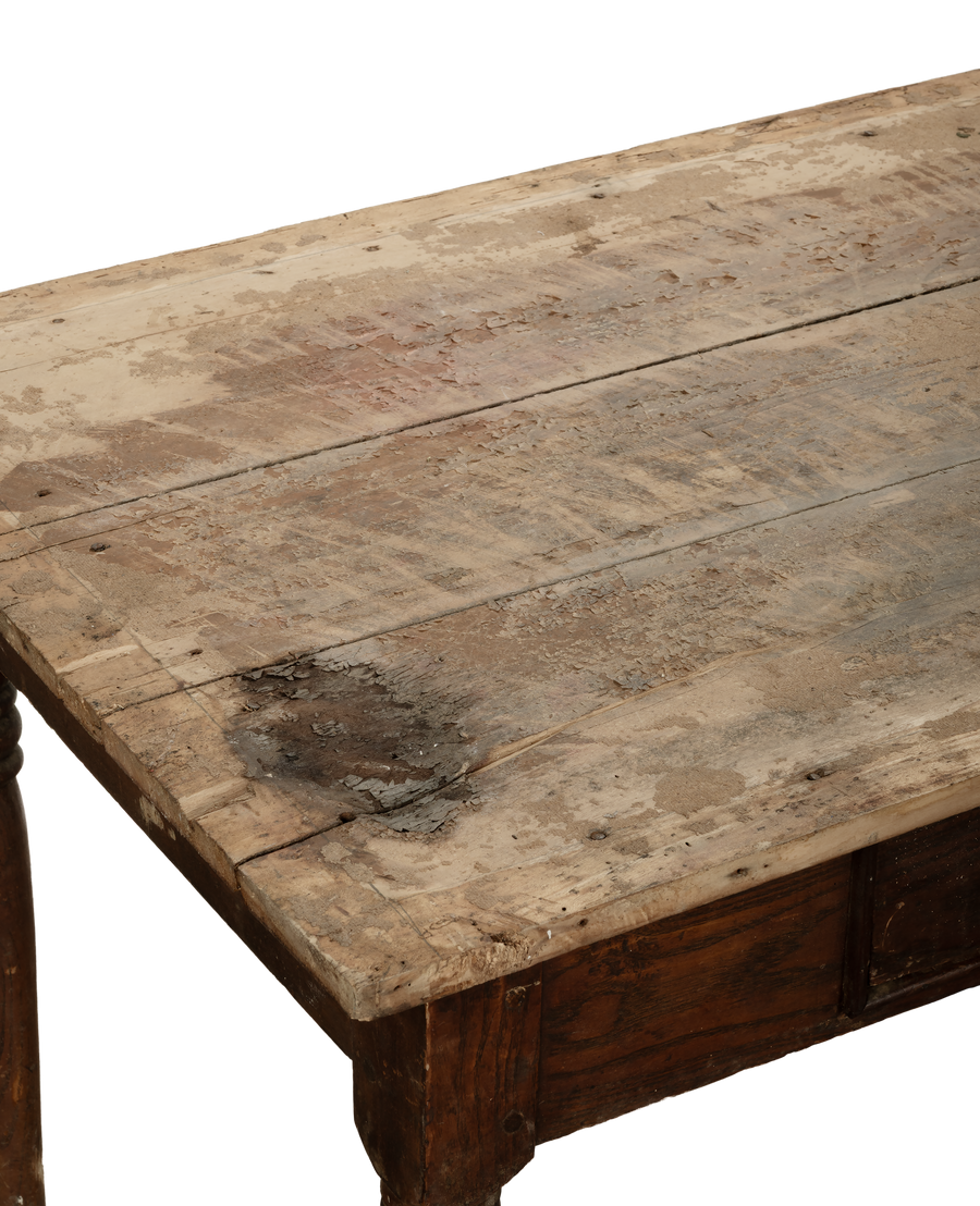 Vintage French oak farm table, distressed top with paint remnants, close-up details.