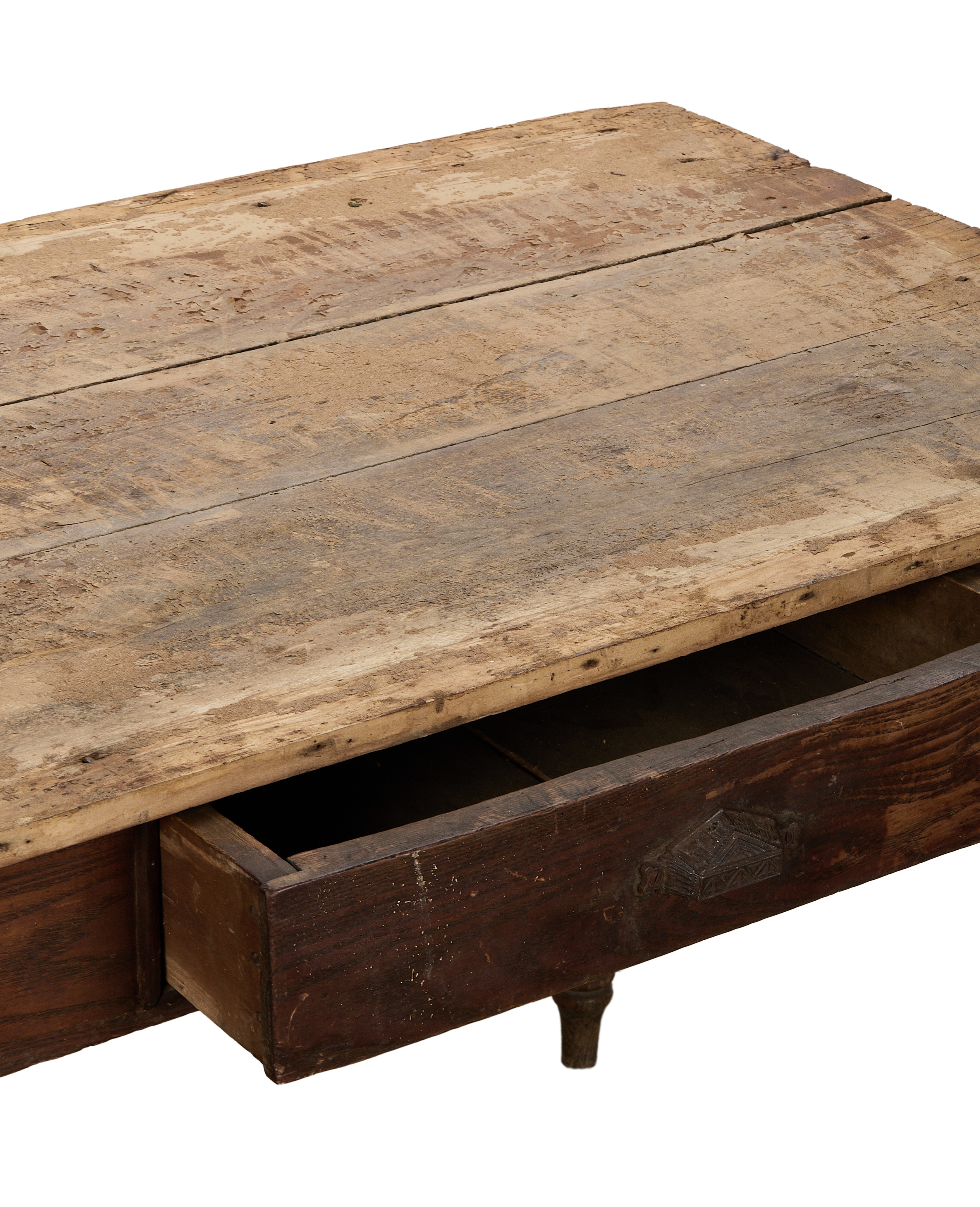 Vintage French oak farm table, showing distressed wooden top and partially opened drawer.