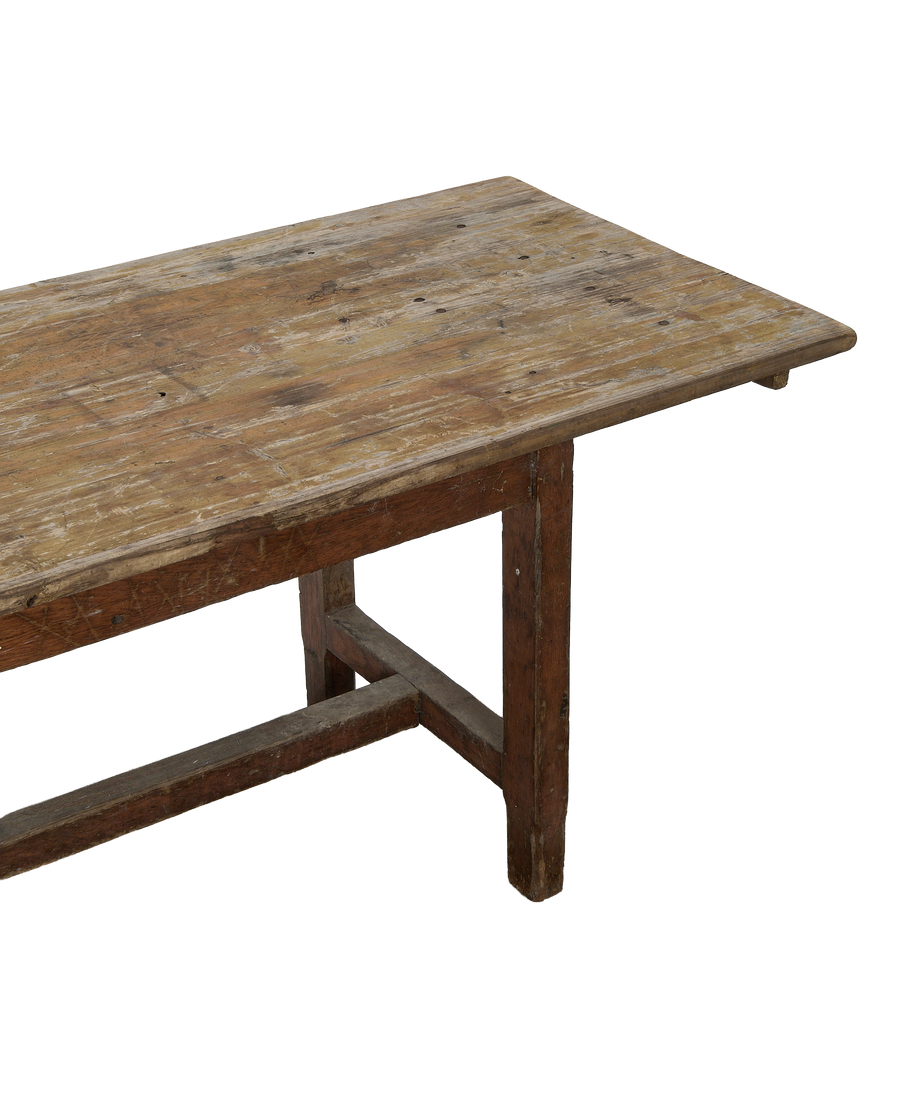 Vintage French oak farm table, showing the distressed tabletop surface and sturdy leg frame detail.