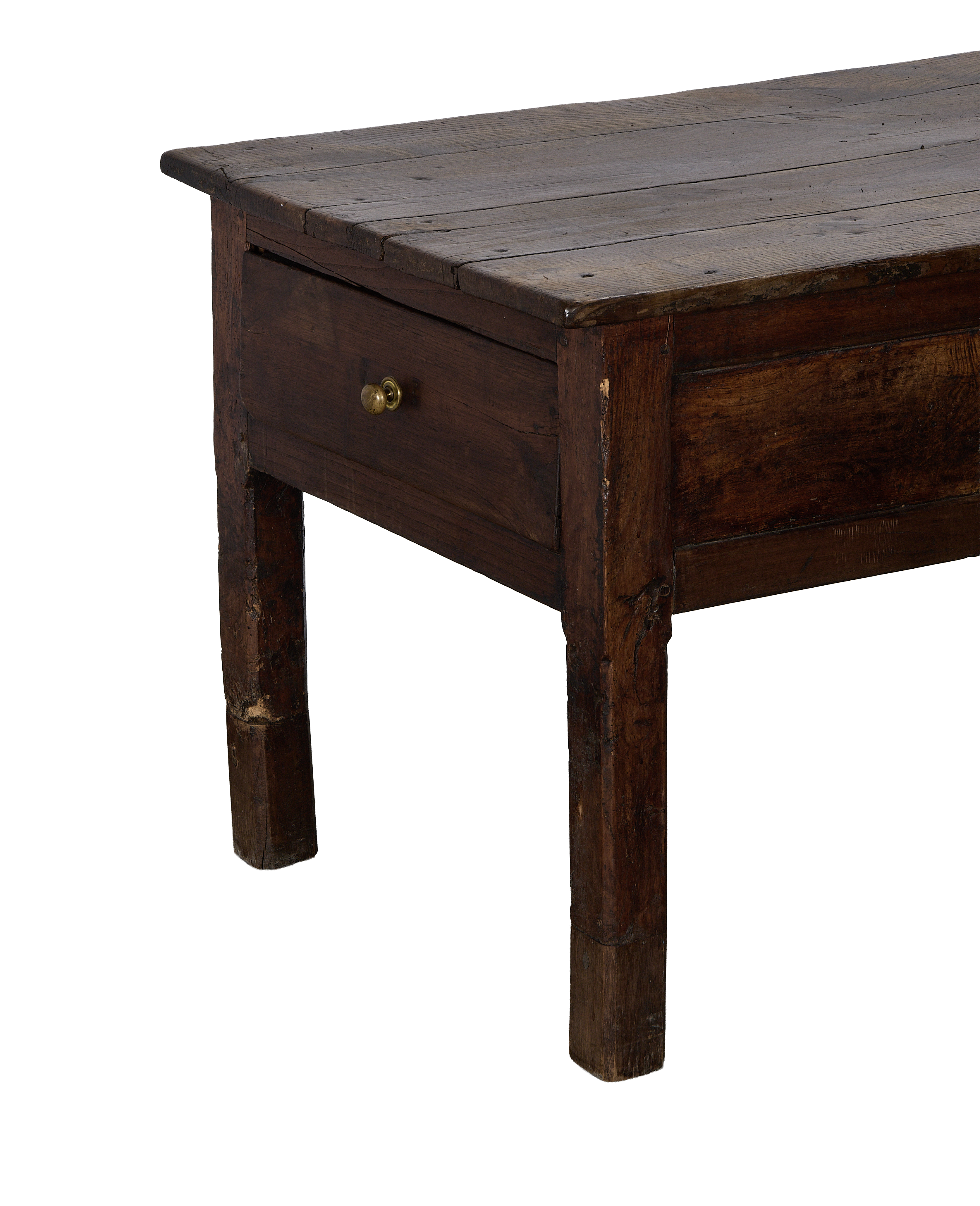 Side angle of vintage French oak drawer table showing brass pull and distressed wood.