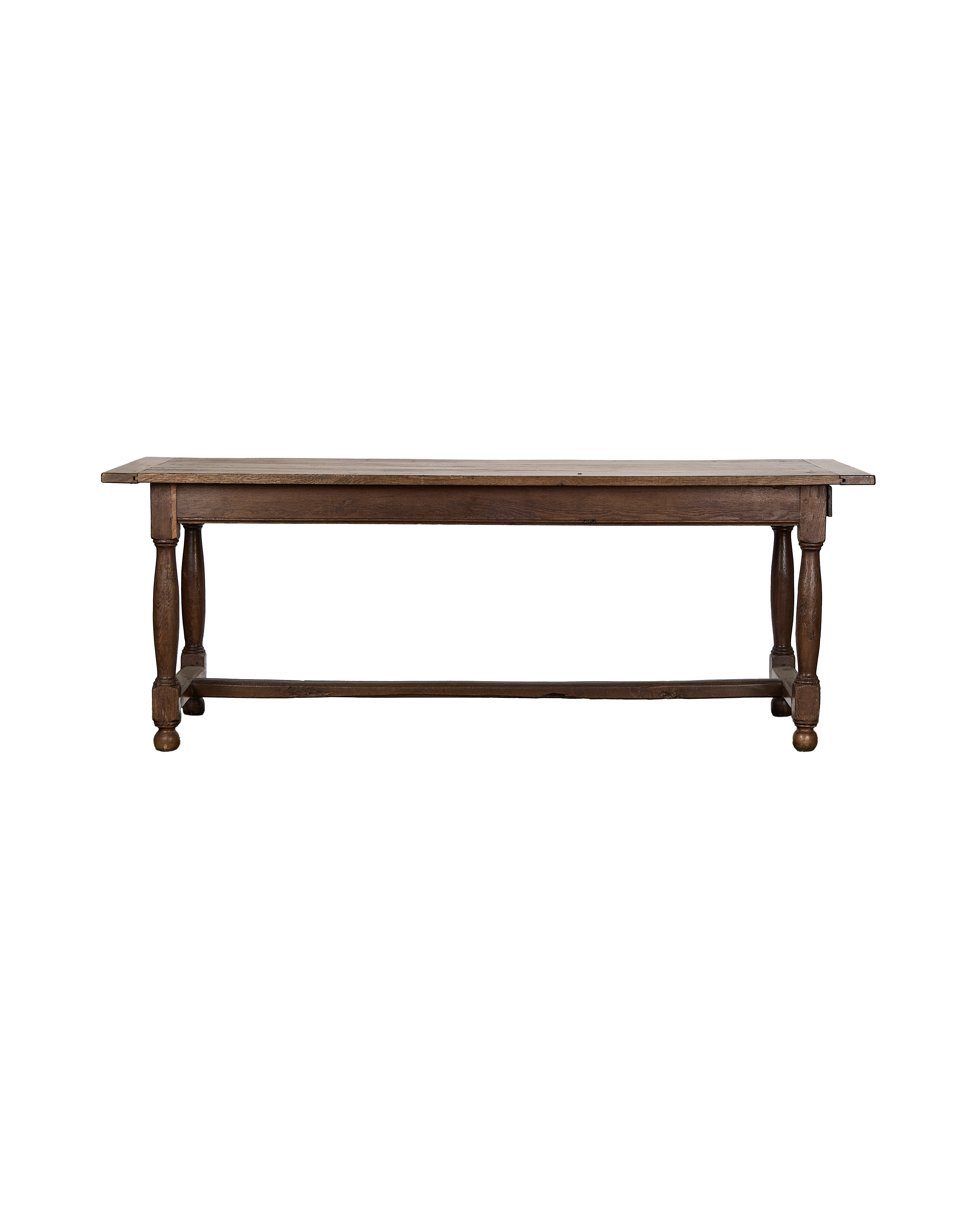Vintage French oak farm table, rich brown, showcasing turned legs and stretcher.