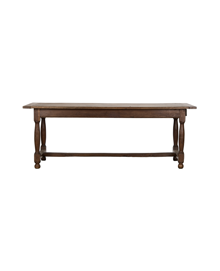 Vintage French oak farm table, rich brown, showcasing turned legs and stretcher.