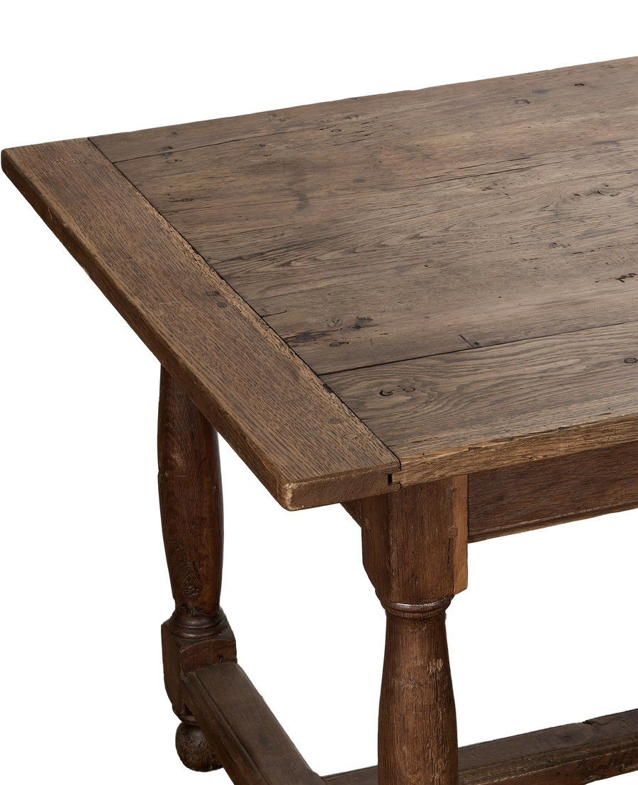 Vintage French oak farm table, rich grain detail on aged plank top.
