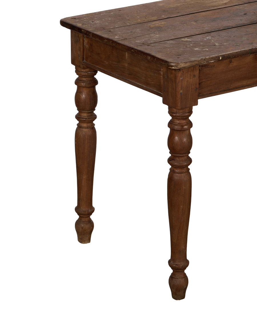 Vintage French oak farm table, showing aged wood grain and turned legs from a low angle.