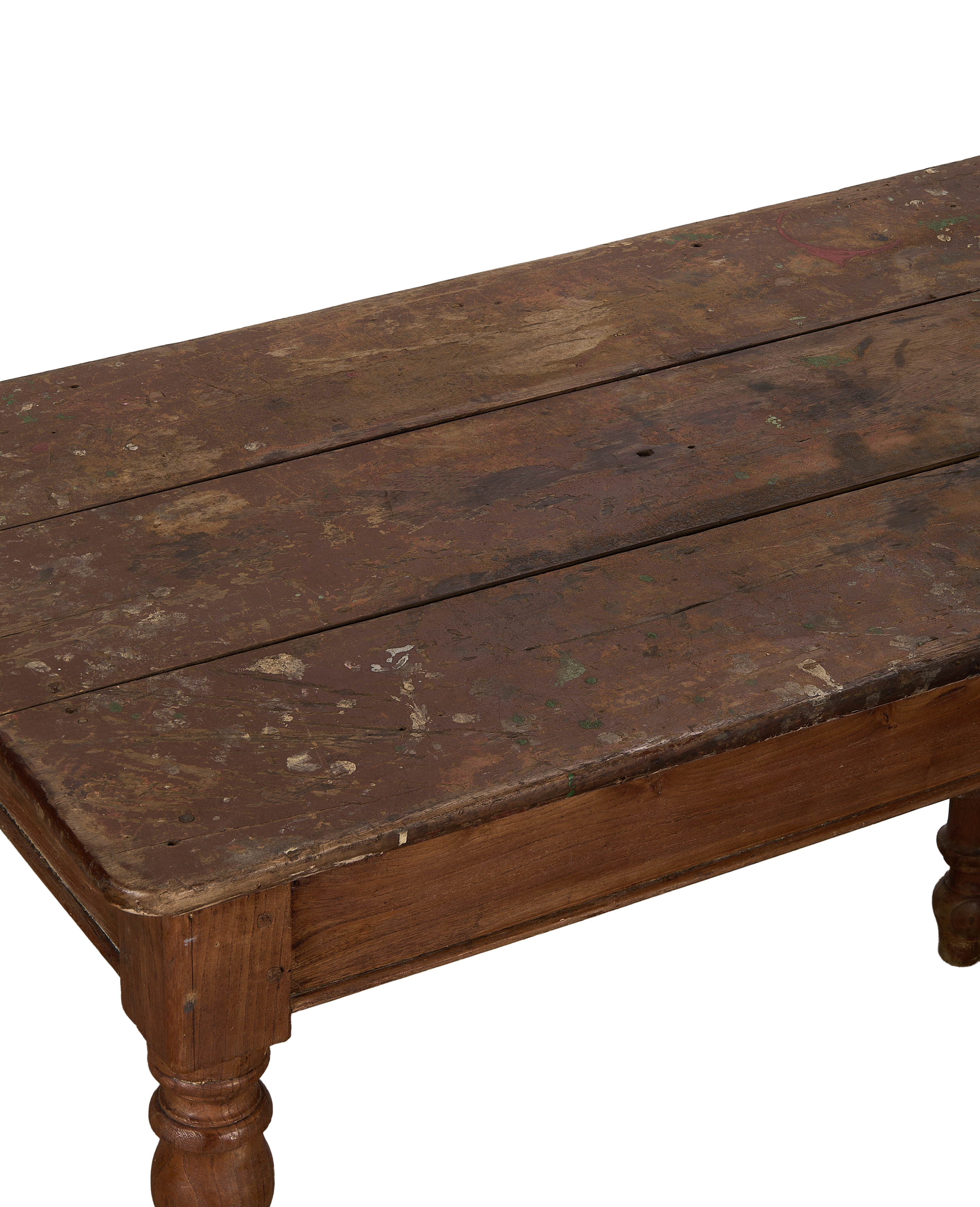 Vintage French oak farm table surface, showcasing distressed reddish-brown wood planks with paint splatters.