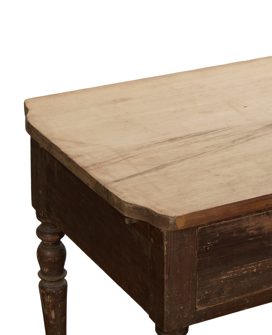 Vintage French oak kitchen island, close-up top view showing light wood surface and dark leg.