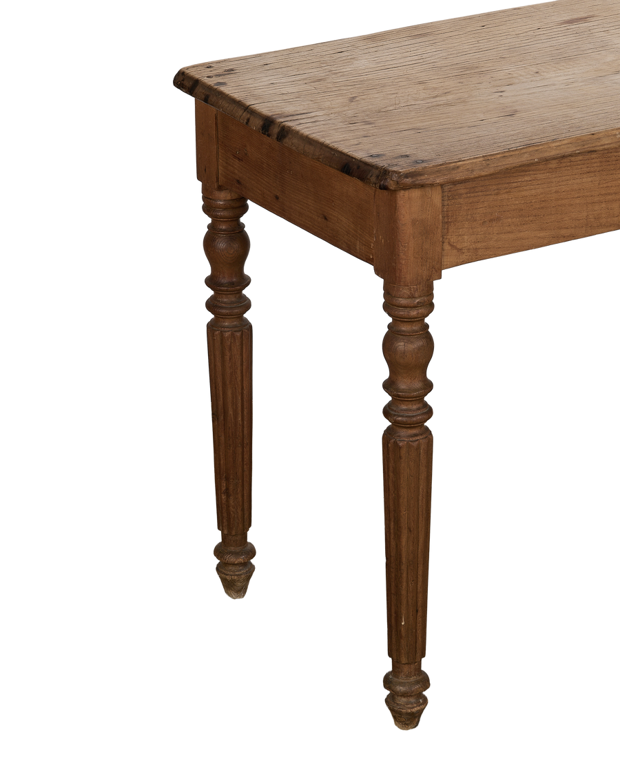 Vintage French oak farm table, showing the turned, fluted legs and distressed wooden top.