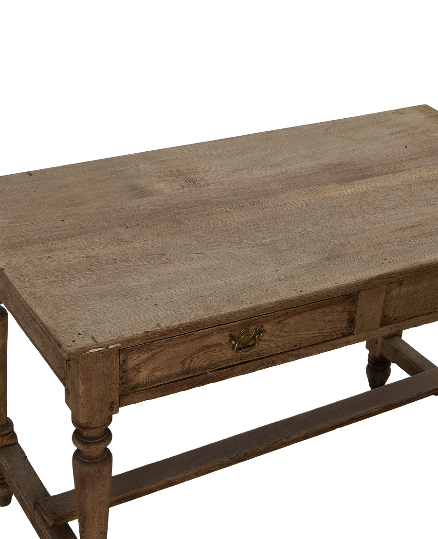 Vintage French oak farm table, showing distressed wooden top and single drawer with brass pull.