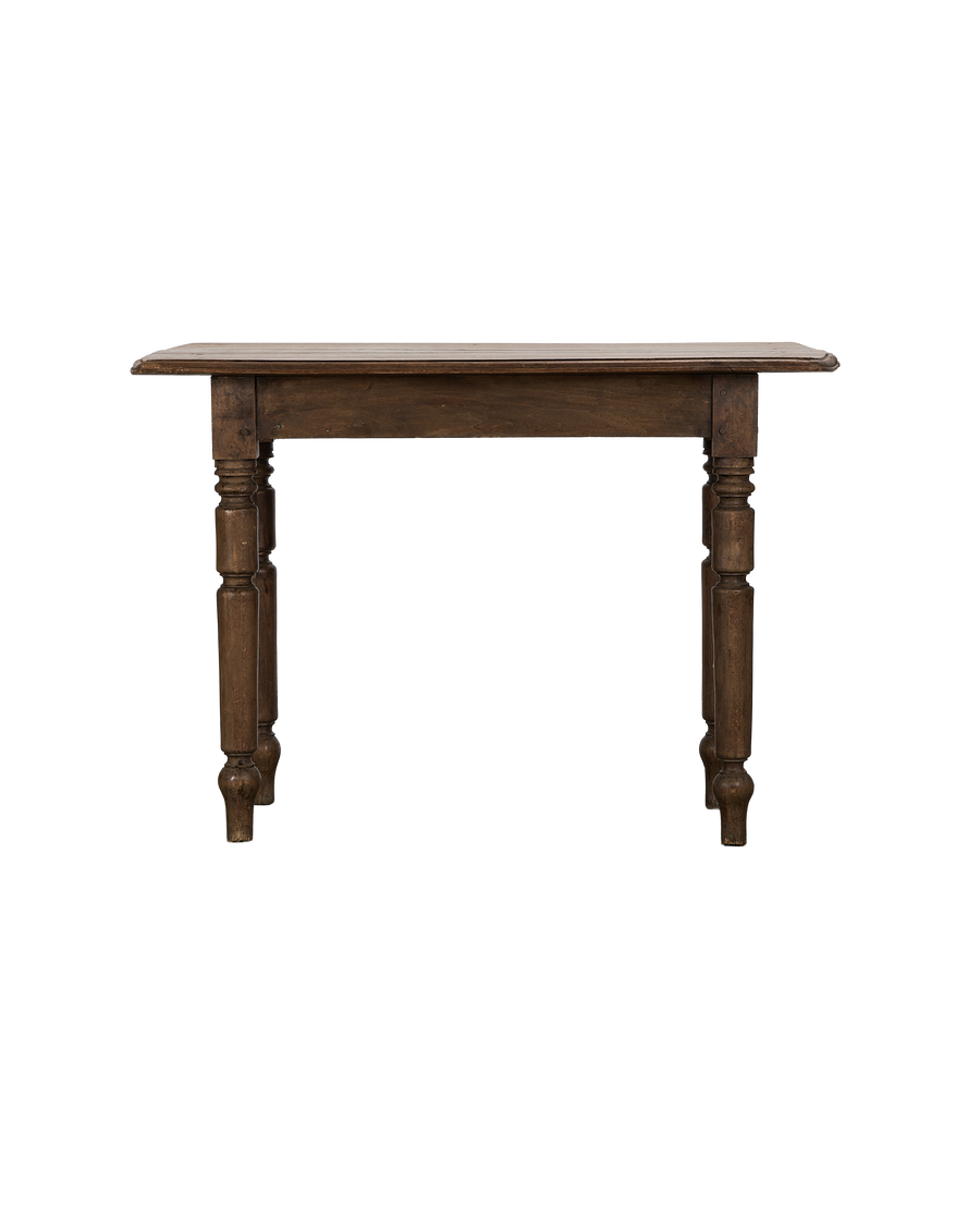 Vintage French oak farm table, showing ornate turned legs and rustic top from front angle.