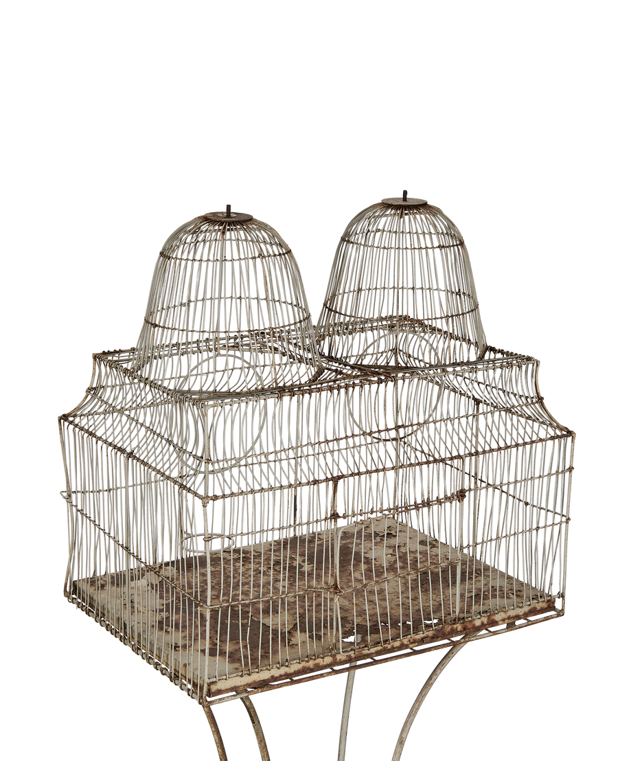 Vintage twin dome bird cage, French oak, showing rusty distressed paint and base.