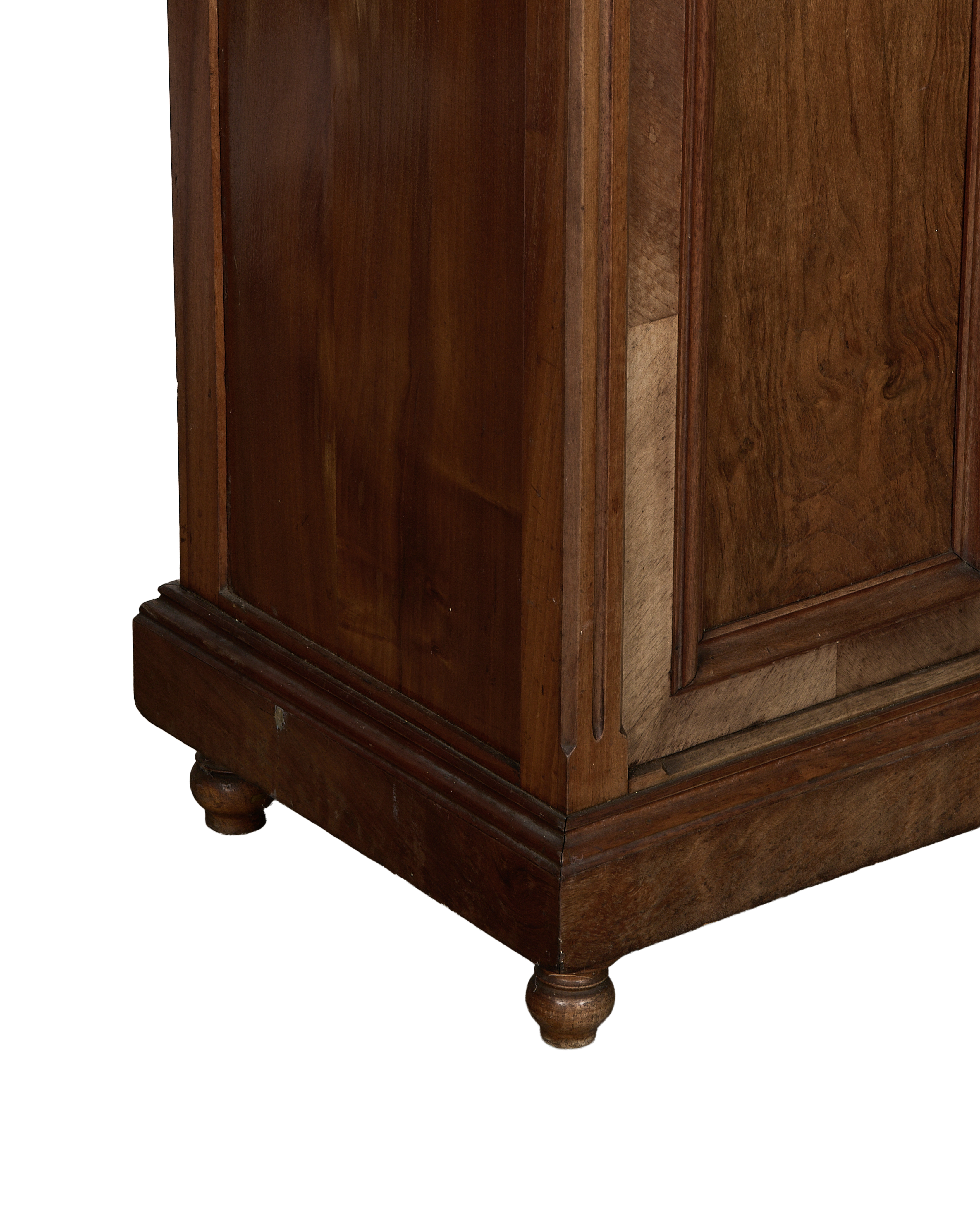 Vintage French oak nightstand, close-up of base with turned feet and worn dark wood.