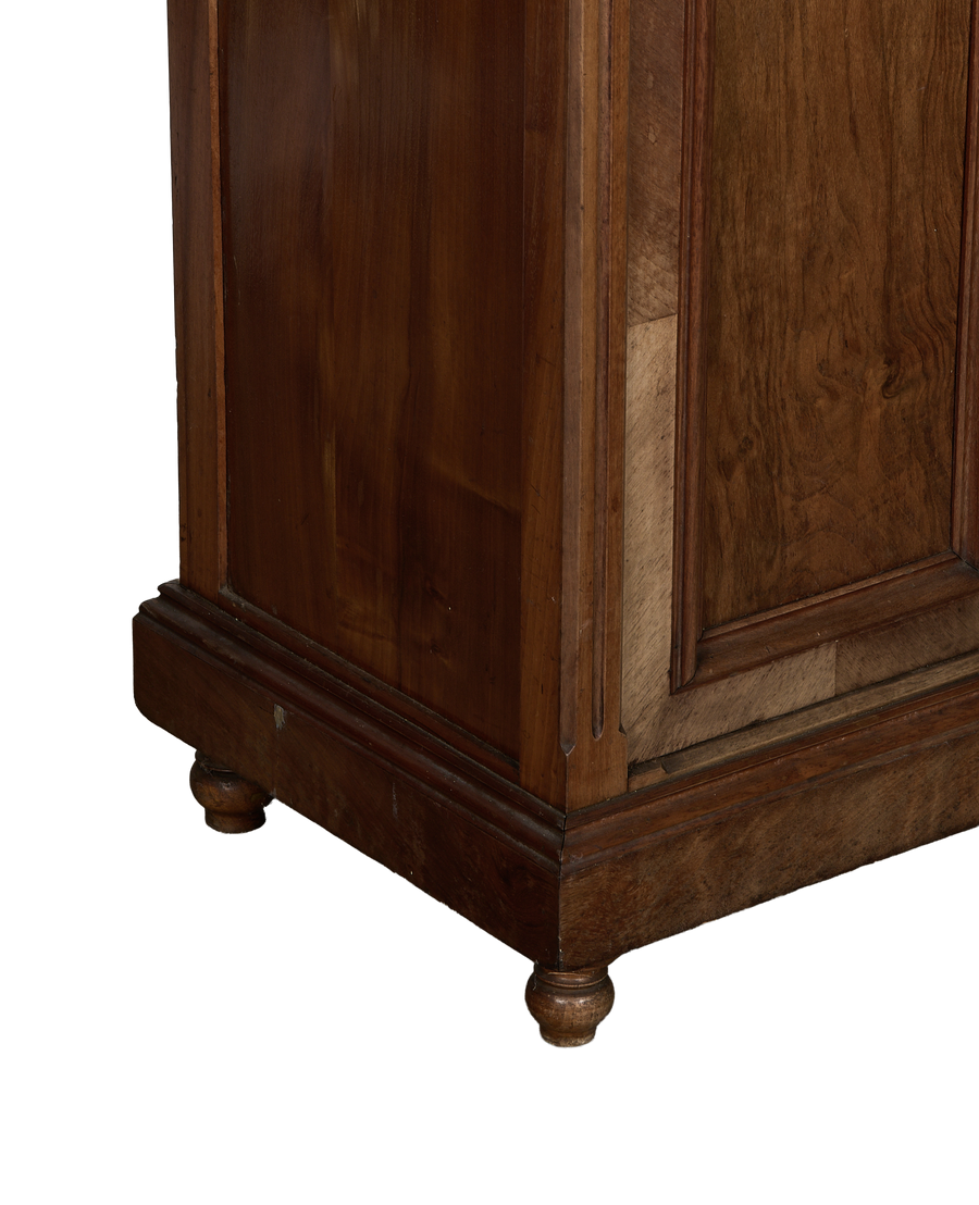 Vintage French oak nightstand, close-up of base with turned feet and worn dark wood.