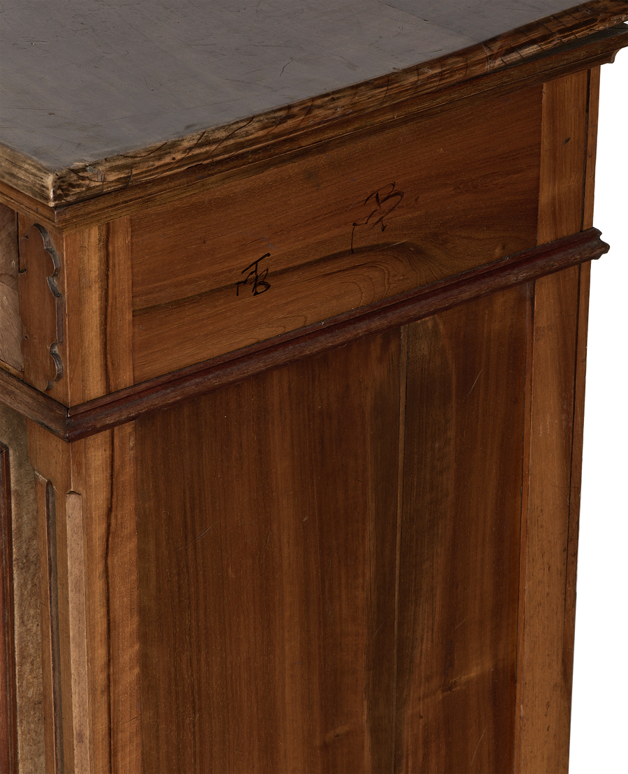 Vintage French oak nightstand: close-up of decorative carved wood corner and dark distressed top.