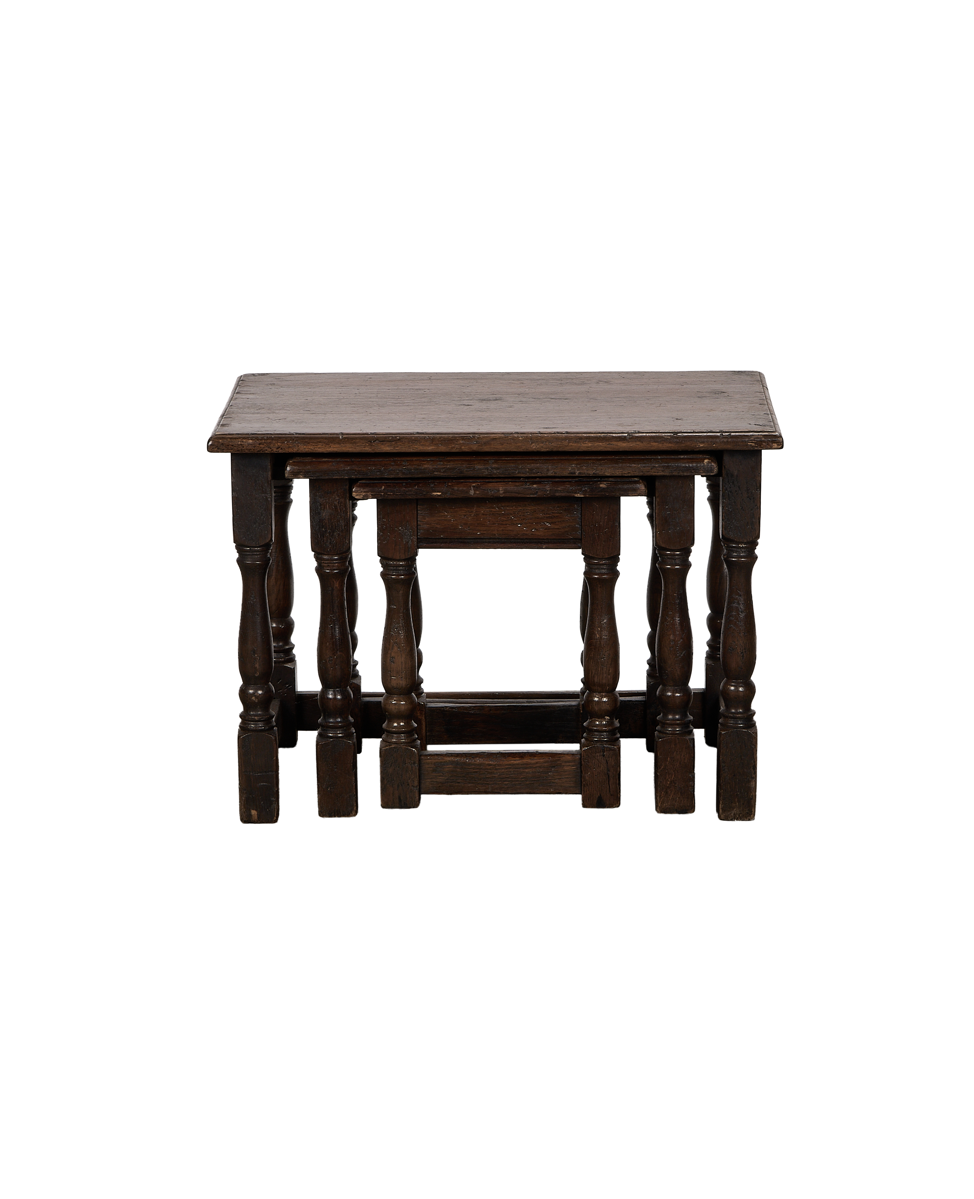 Vintage French oak nesting side tables, nested showing scrolled legs and dark patina.