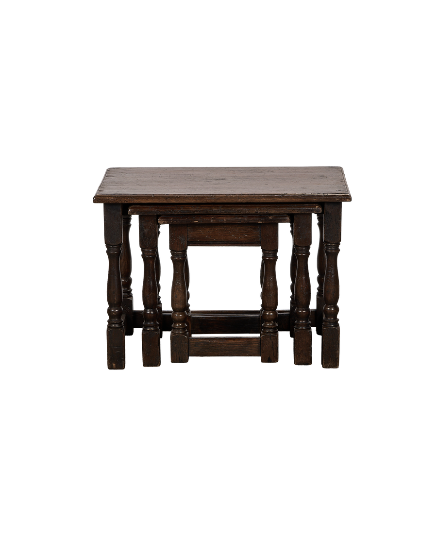 Vintage French oak nesting side tables, nested showing scrolled legs and dark patina.