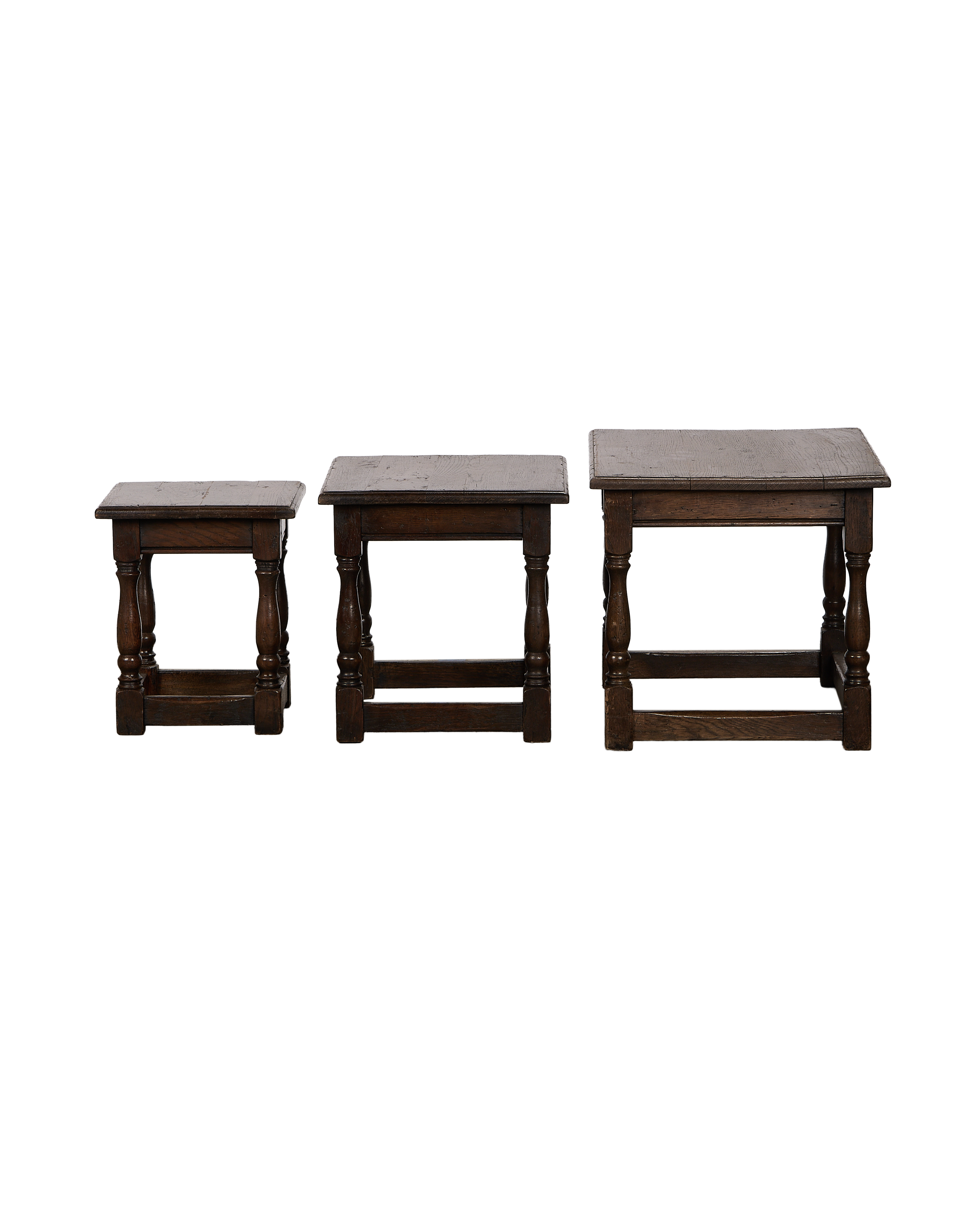 Vintage French oak nesting side tables, set of three, showcasing various sizes.