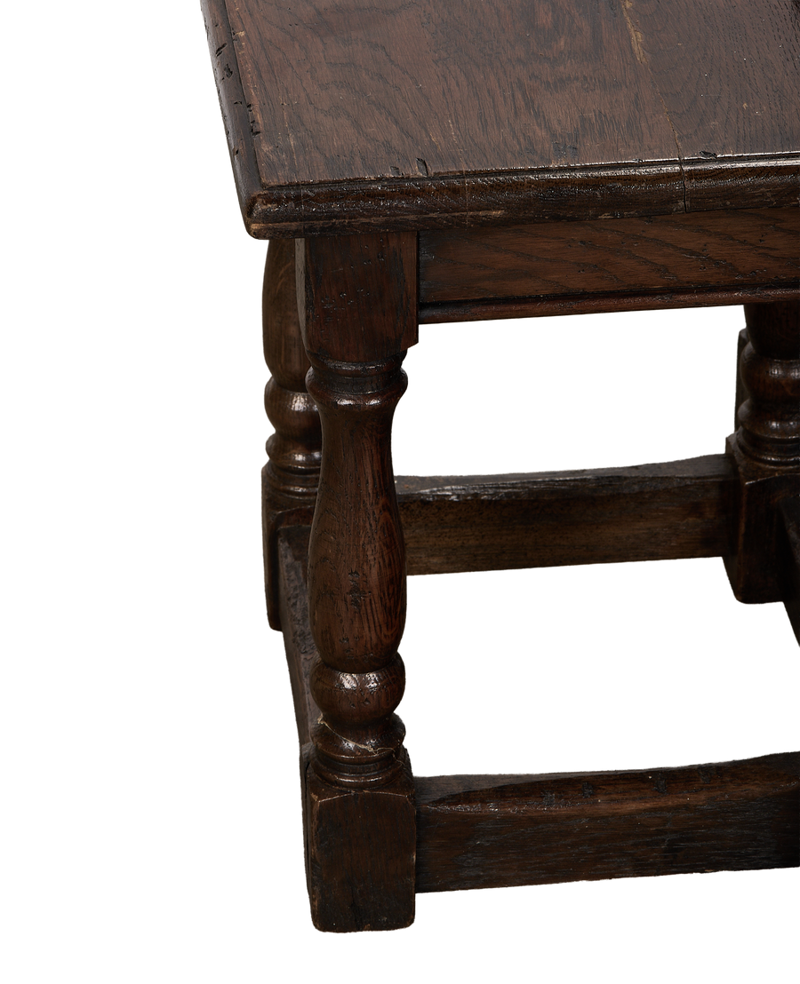 Vintage French oak nesting table close-up, showing detailed turned leg, dark patina.
