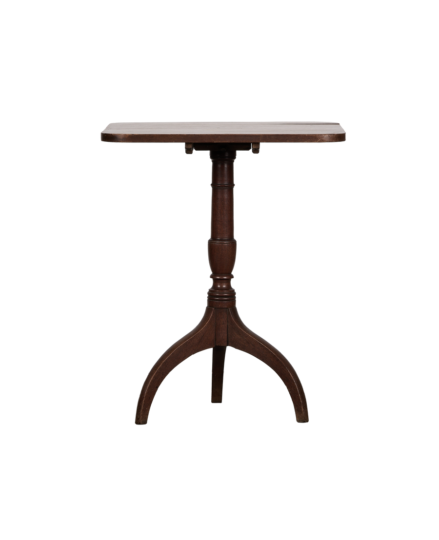 Vintage French folding oak bistro table from the side, showcasing the rounded brown top and tripod base.