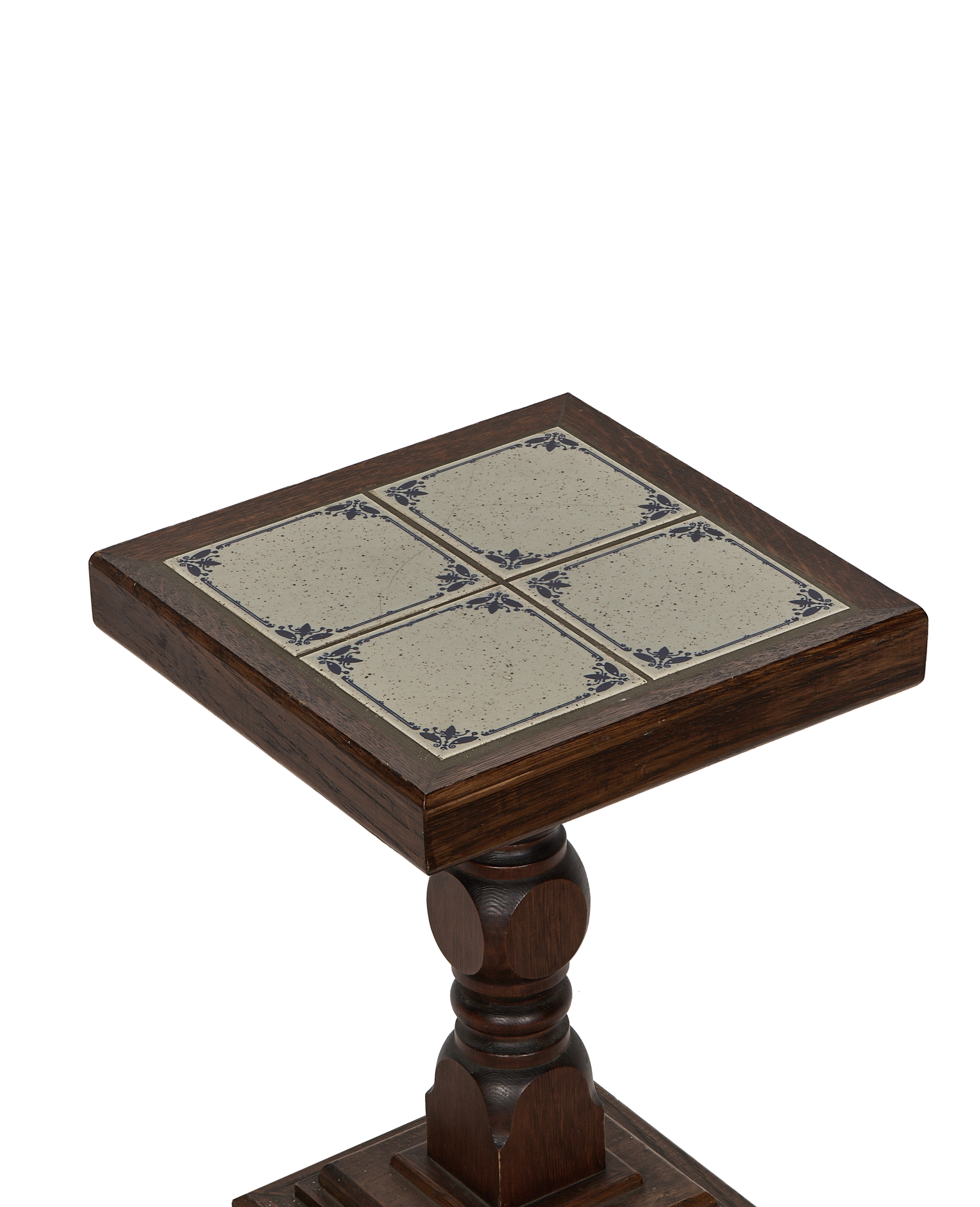 Vintage French oak side table, detailed close-up of Delft tile top design and ornate leg.