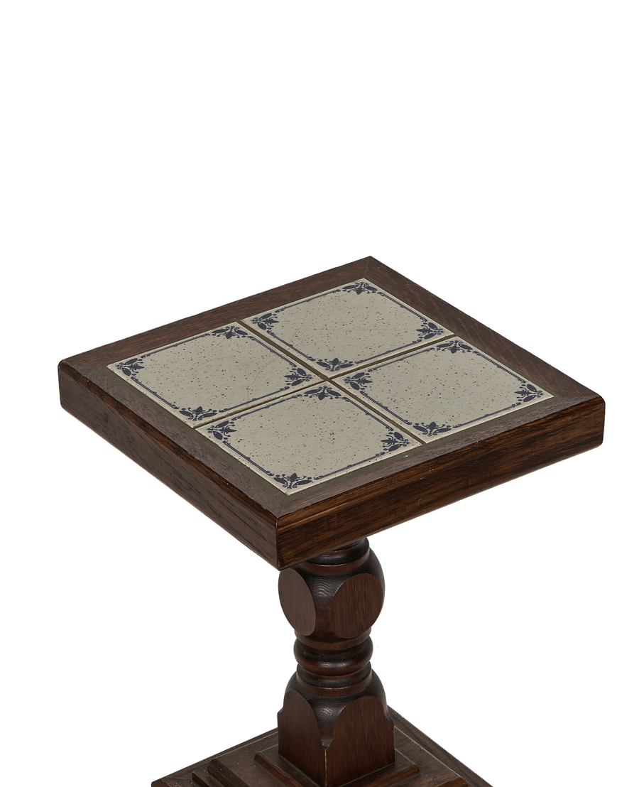 Vintage French oak side table, detailed close-up of Delft tile top design and ornate leg.