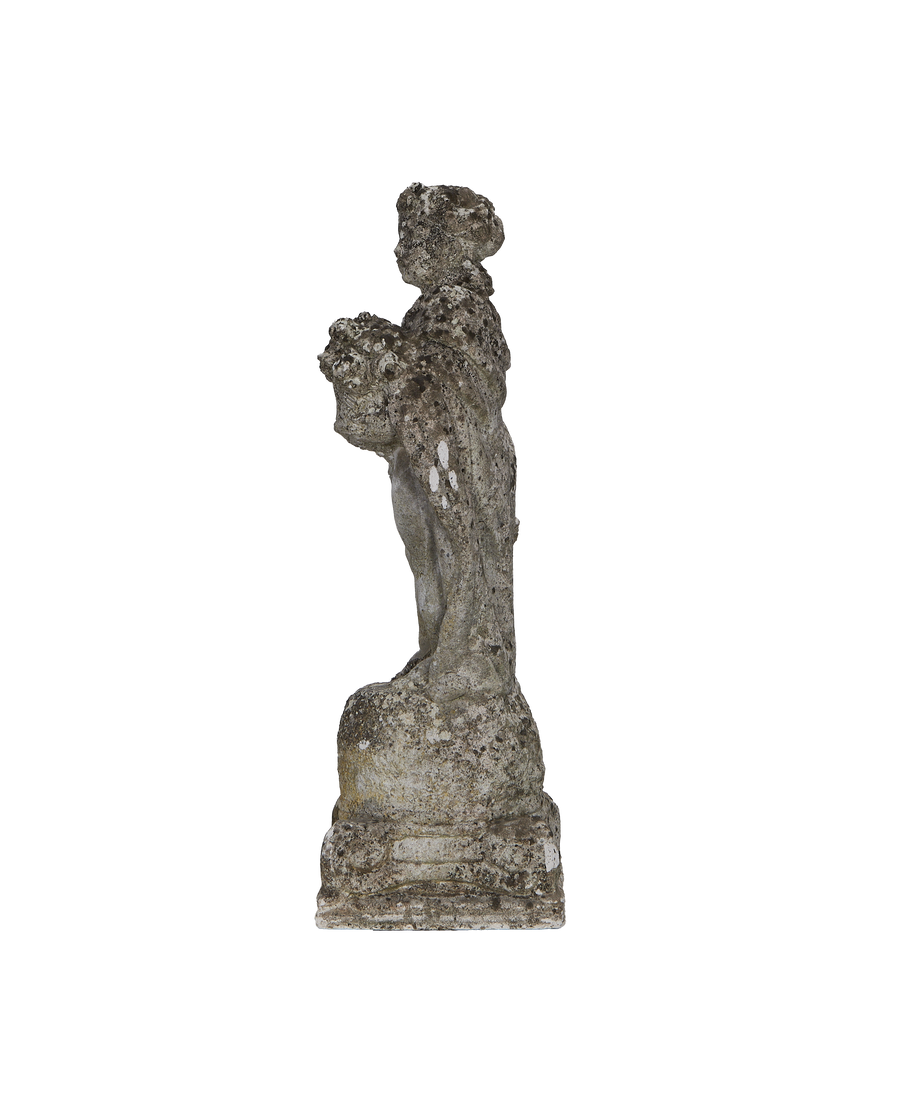 Vintage concrete girl statue, offering flowers, weathered French garden ornament, side view.
