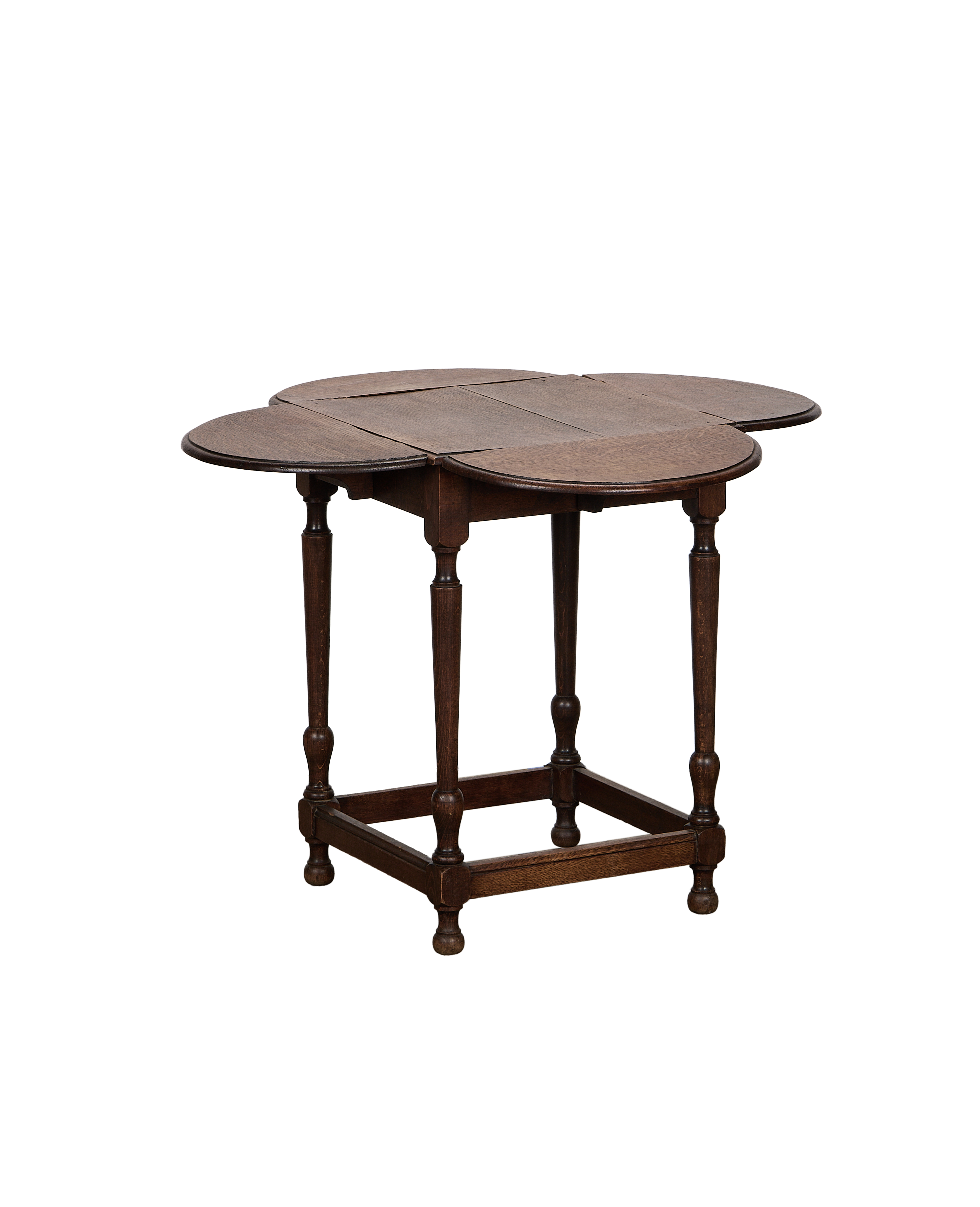 Vintage French oak clover drop leaf table, partially open, showcasing turned legs and stretcher base.