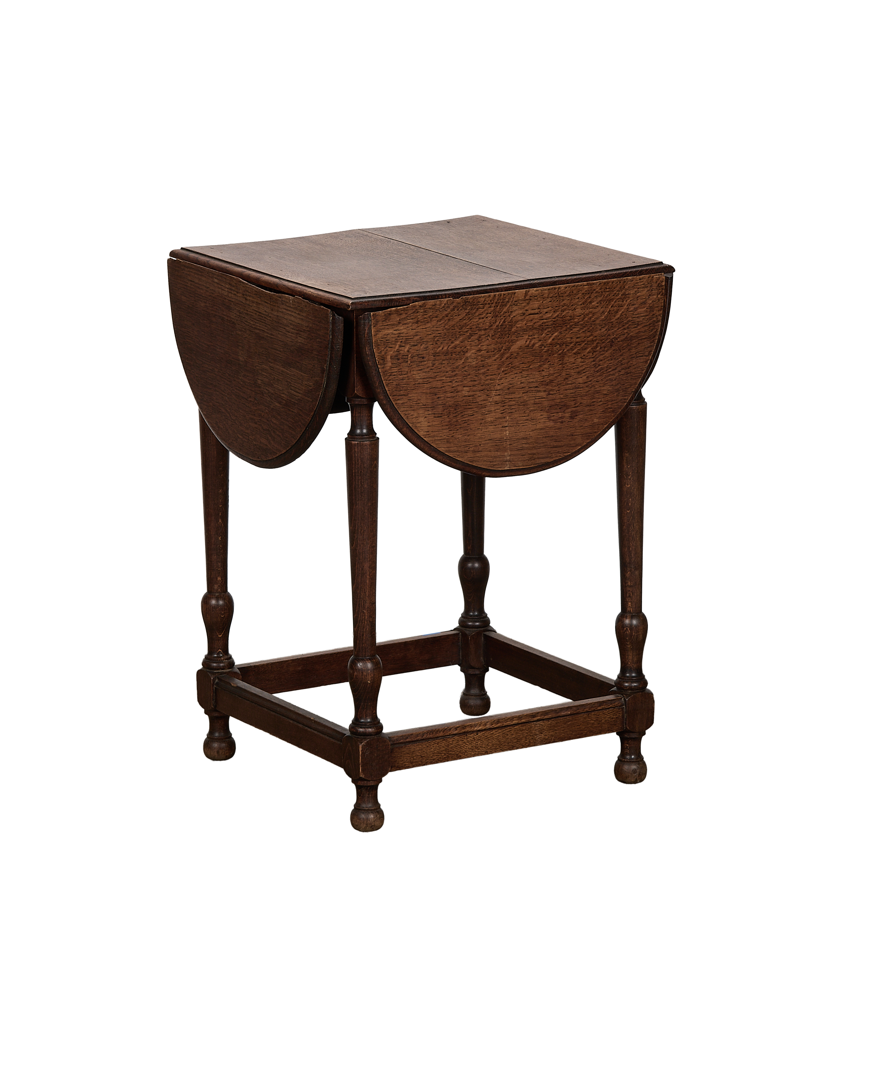 Vintage French oak clover drop leaf table, partially open, showing rich wood grain.