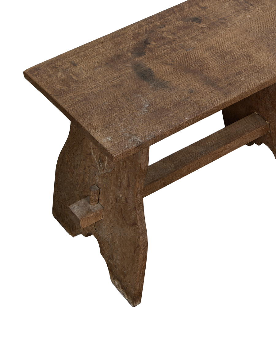 Vintage French oak church stool, close-up top view, showing aged wood grain and dovetail joinery.