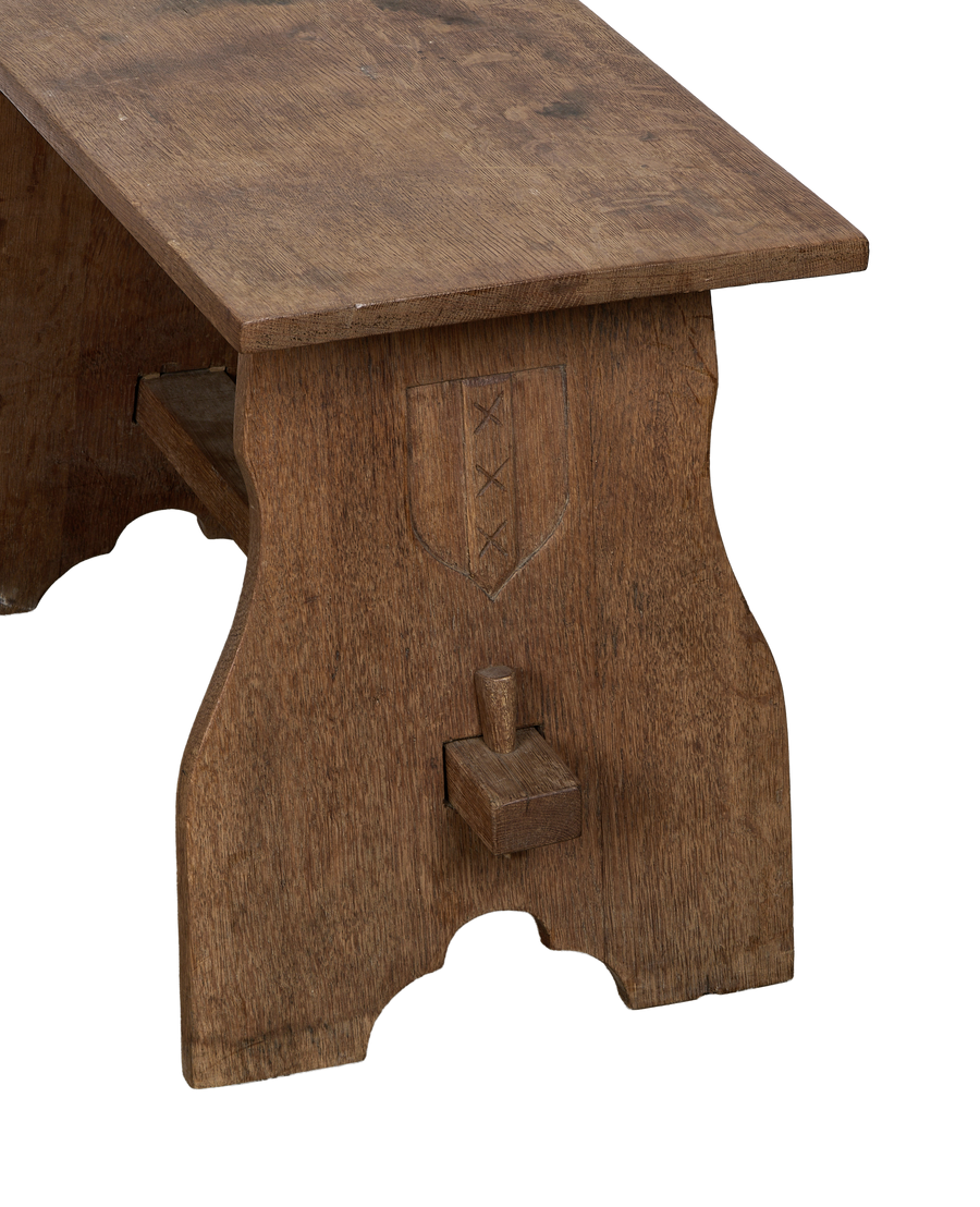 Vintage French oak church stool: side view, showing carved shield with three crosses.