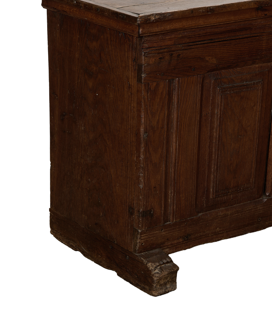 Vintage French oak chest showing detailed, weathered wood grain and base.