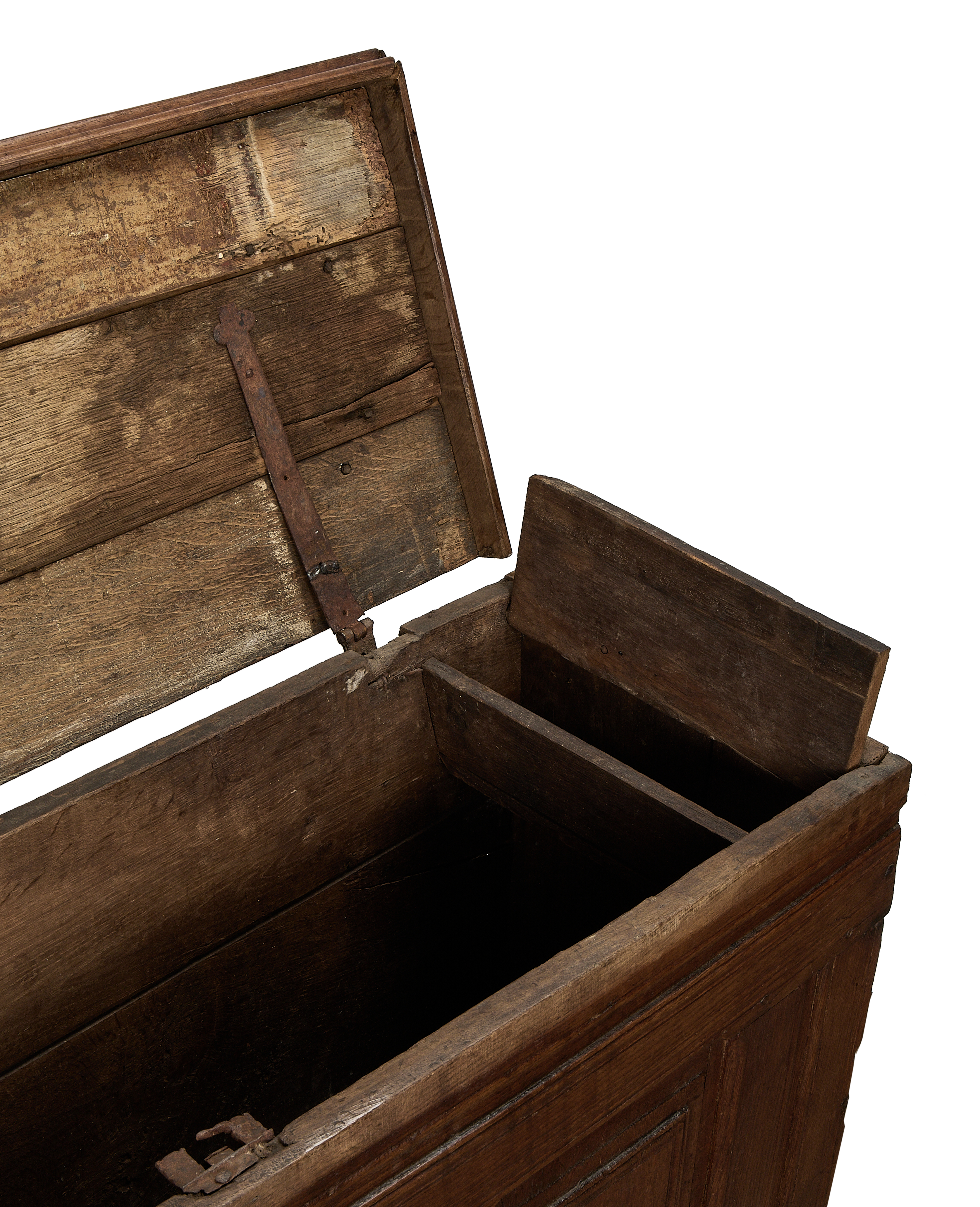 Vintage French oak chest interior, showing distressed wood, rusted hinge, and internal storage compartment.