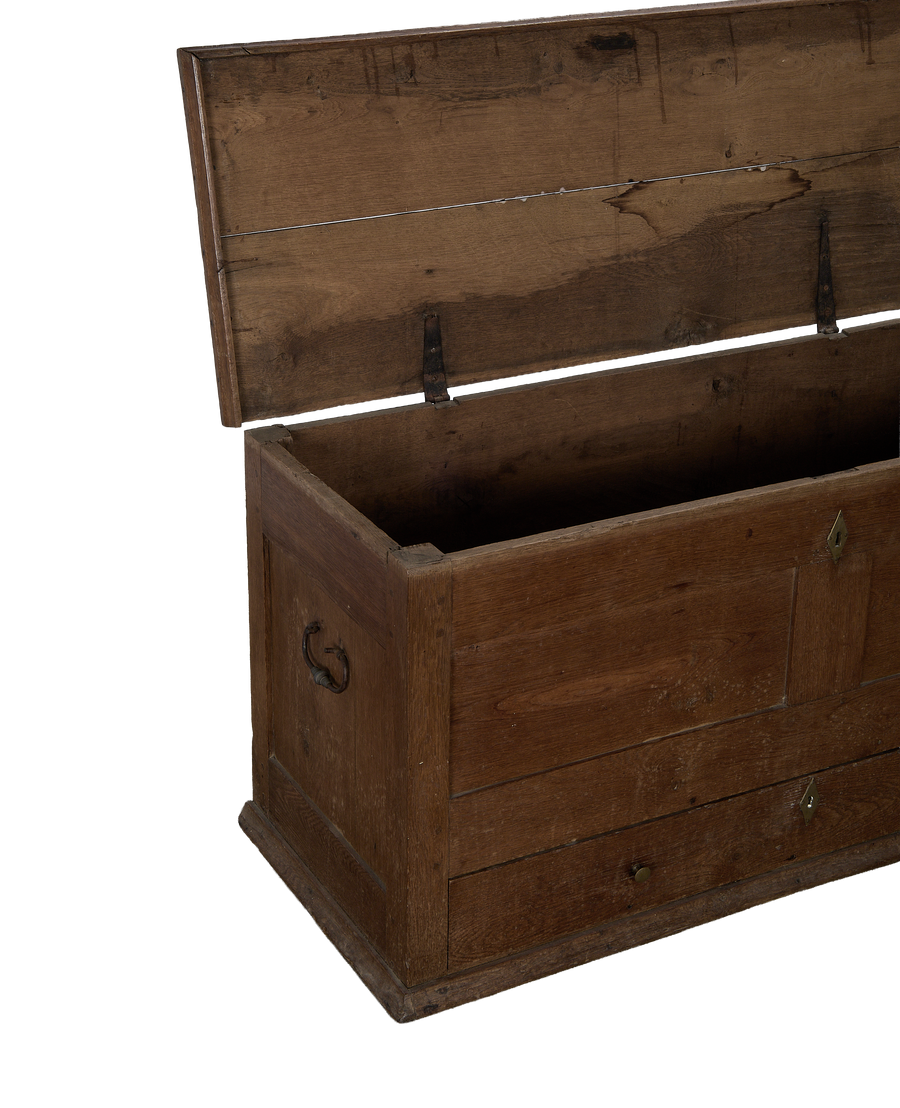 Open lid of vintage French oak chest, showcasing interior storage and sturdy iron hinges.
