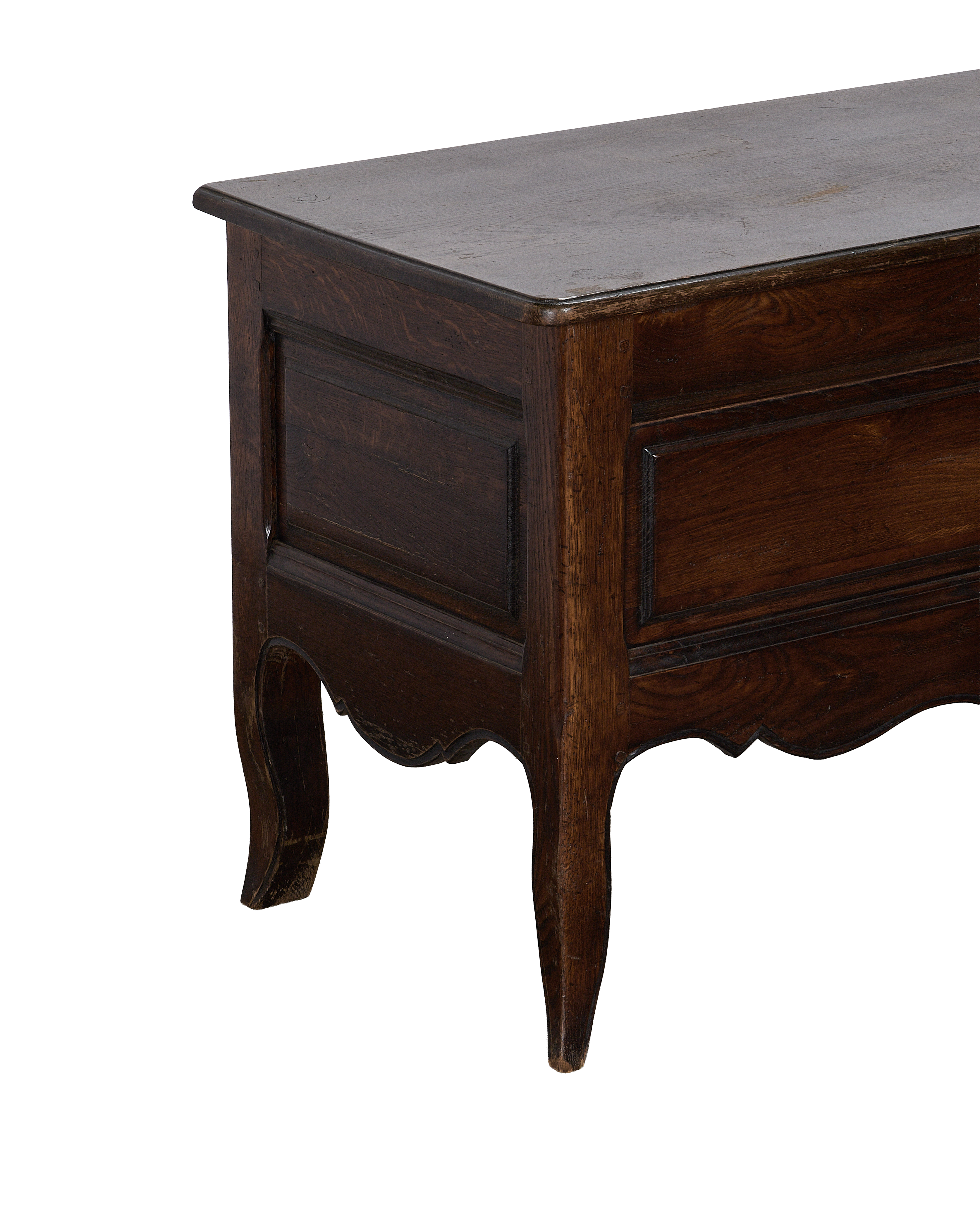 Vintage French oak chest, close up of rustic dark wood grain and decorative scalloped base.