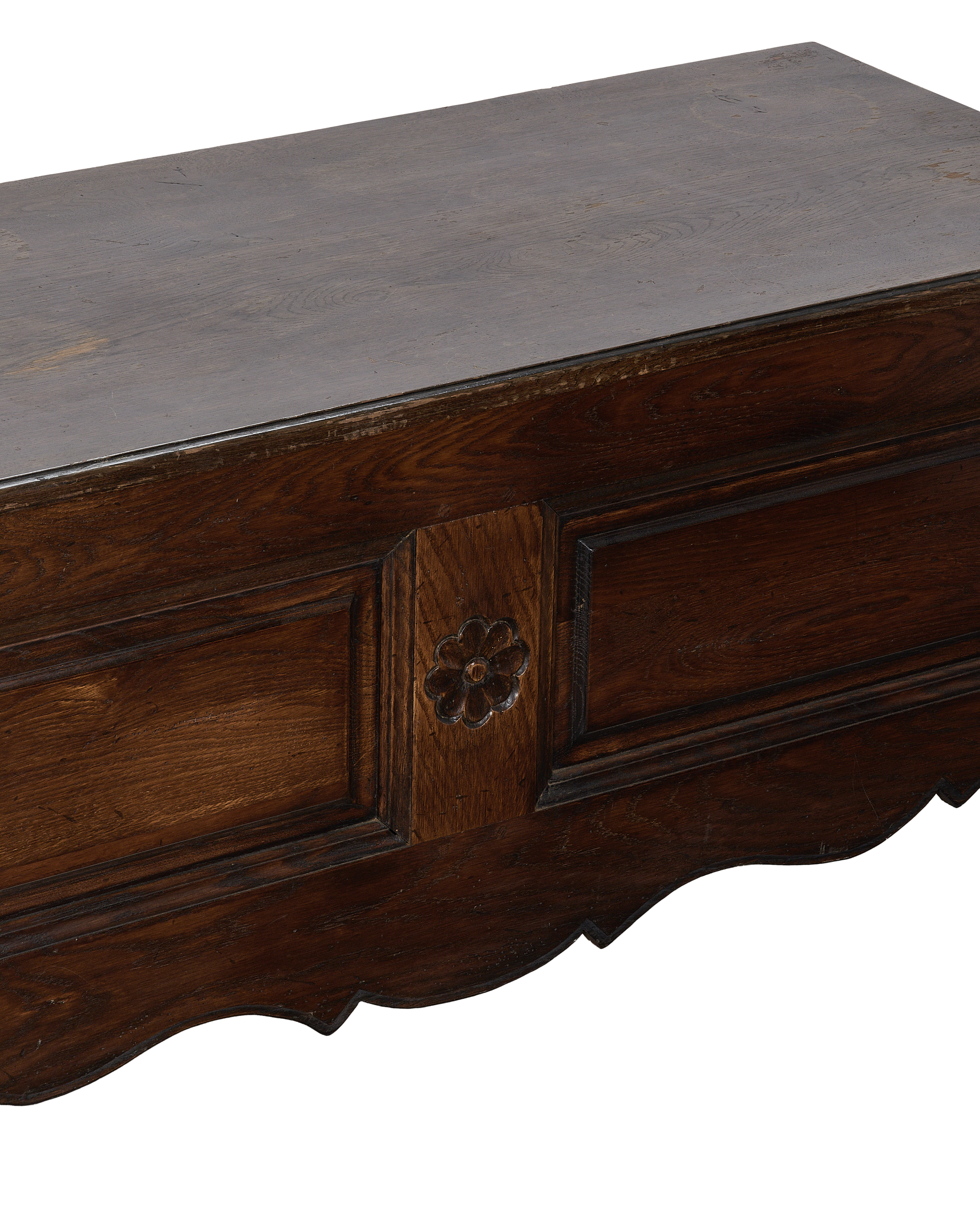 Vintage French oak chest detail, showing ornate floral carving and distressed dark wood top.