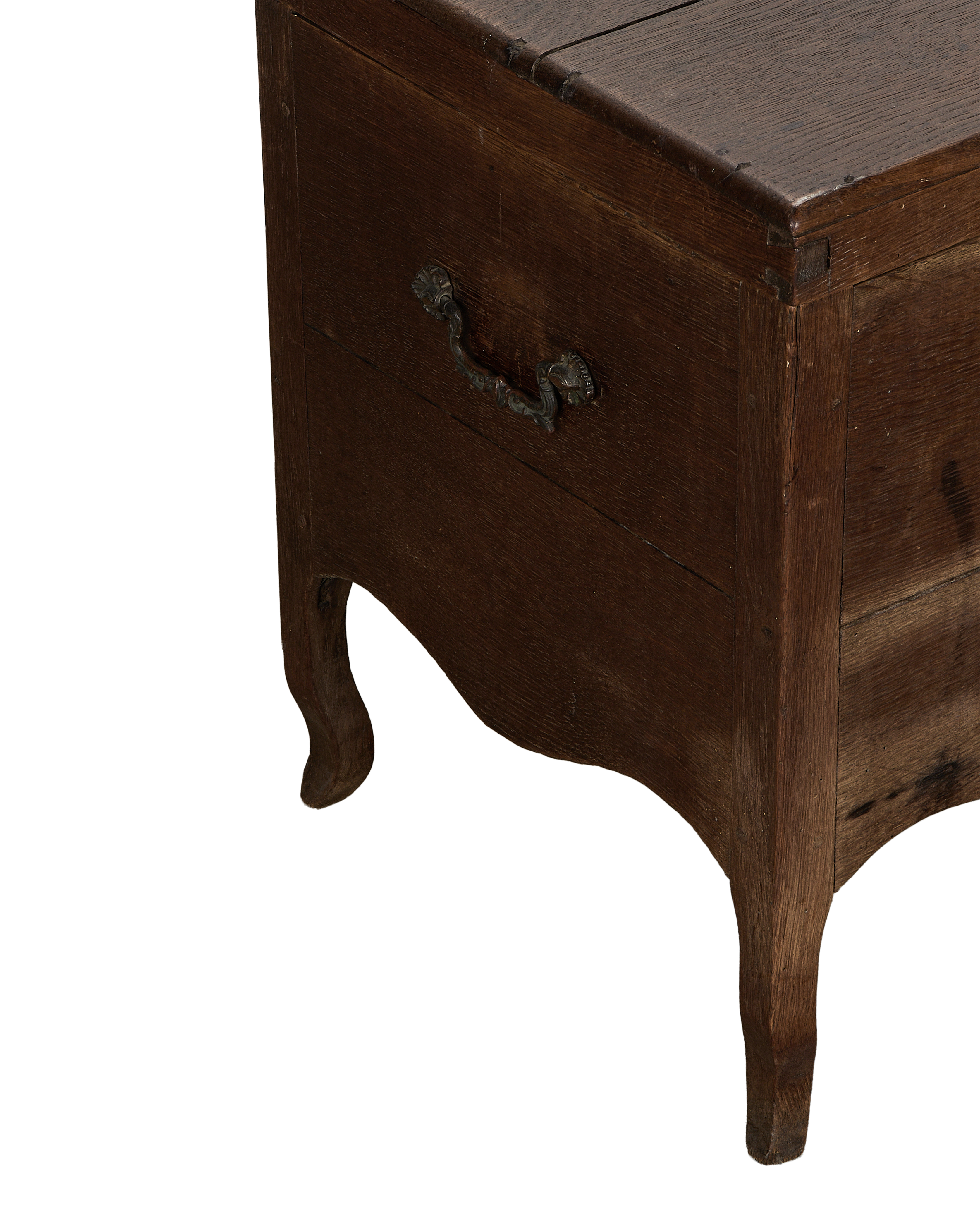 Vintage French oak chest angled close-up, ornate metal handle, and curved leg.