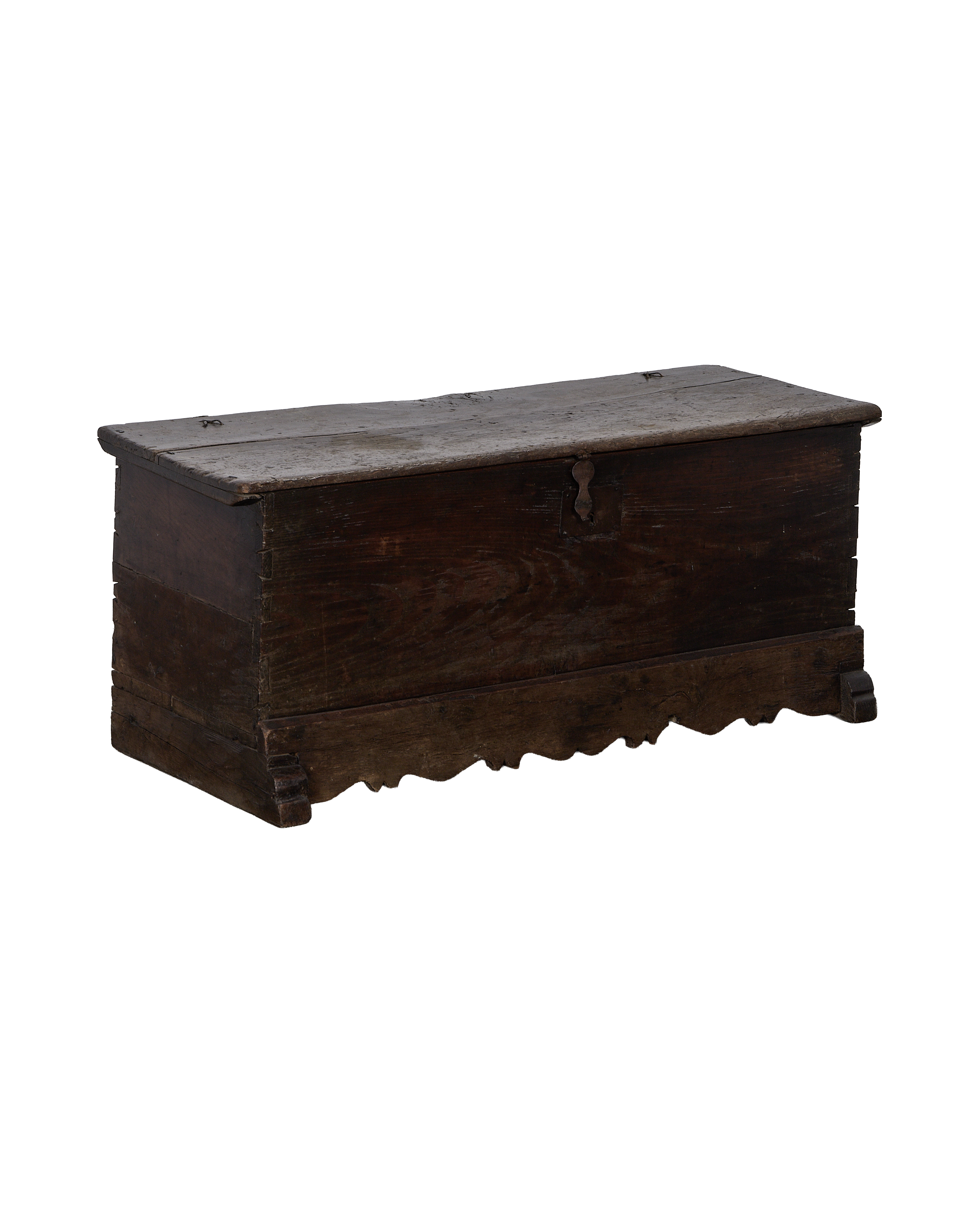 Vintage French oak chest showing iron escutcheon and decorative scalloped base.