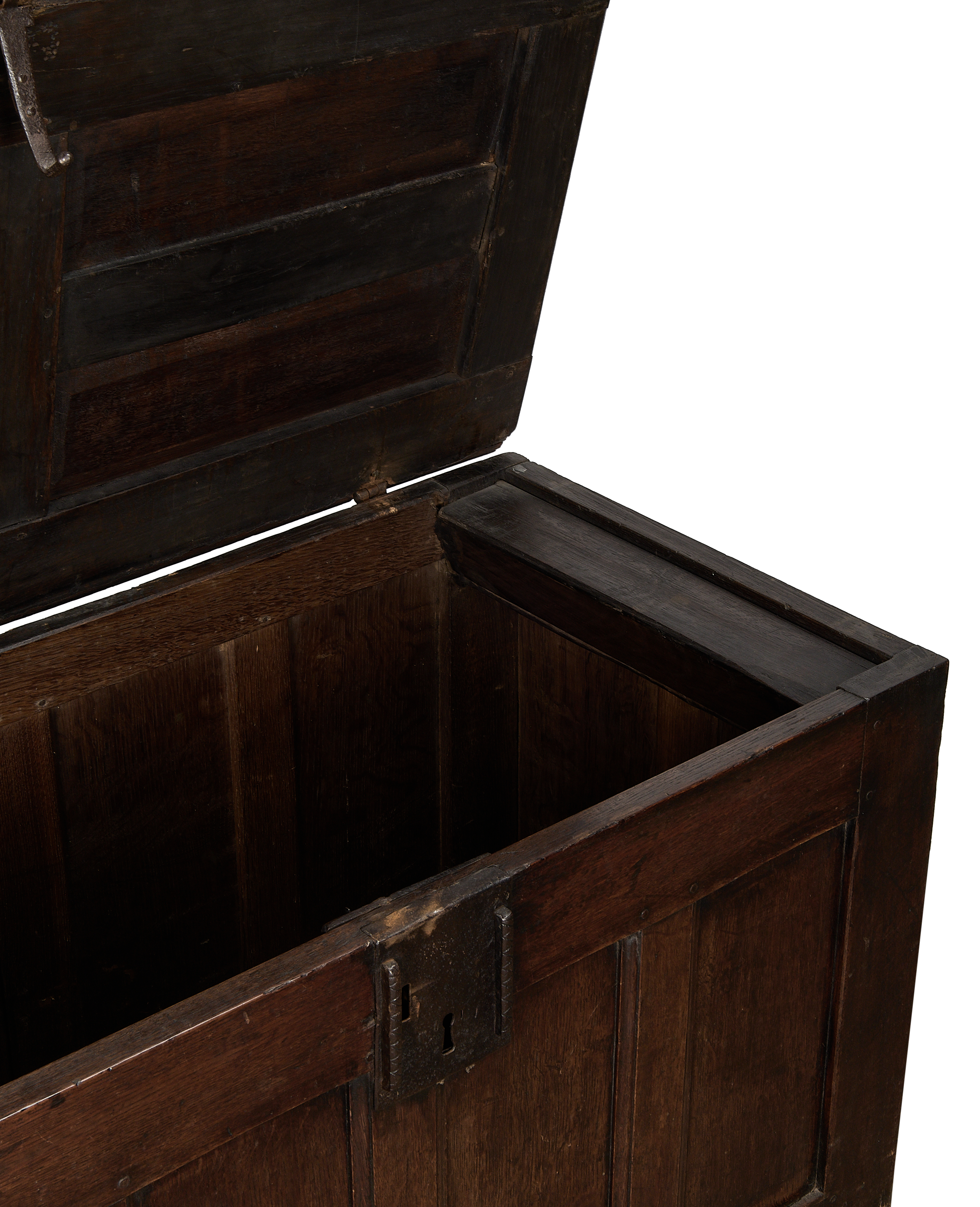 Open vintage dark oak English trunk, showing interior grain and antique iron lock.
