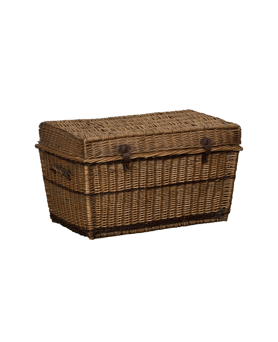 Vintage French rectangular wicker chest, side view showing distressed metal latches.