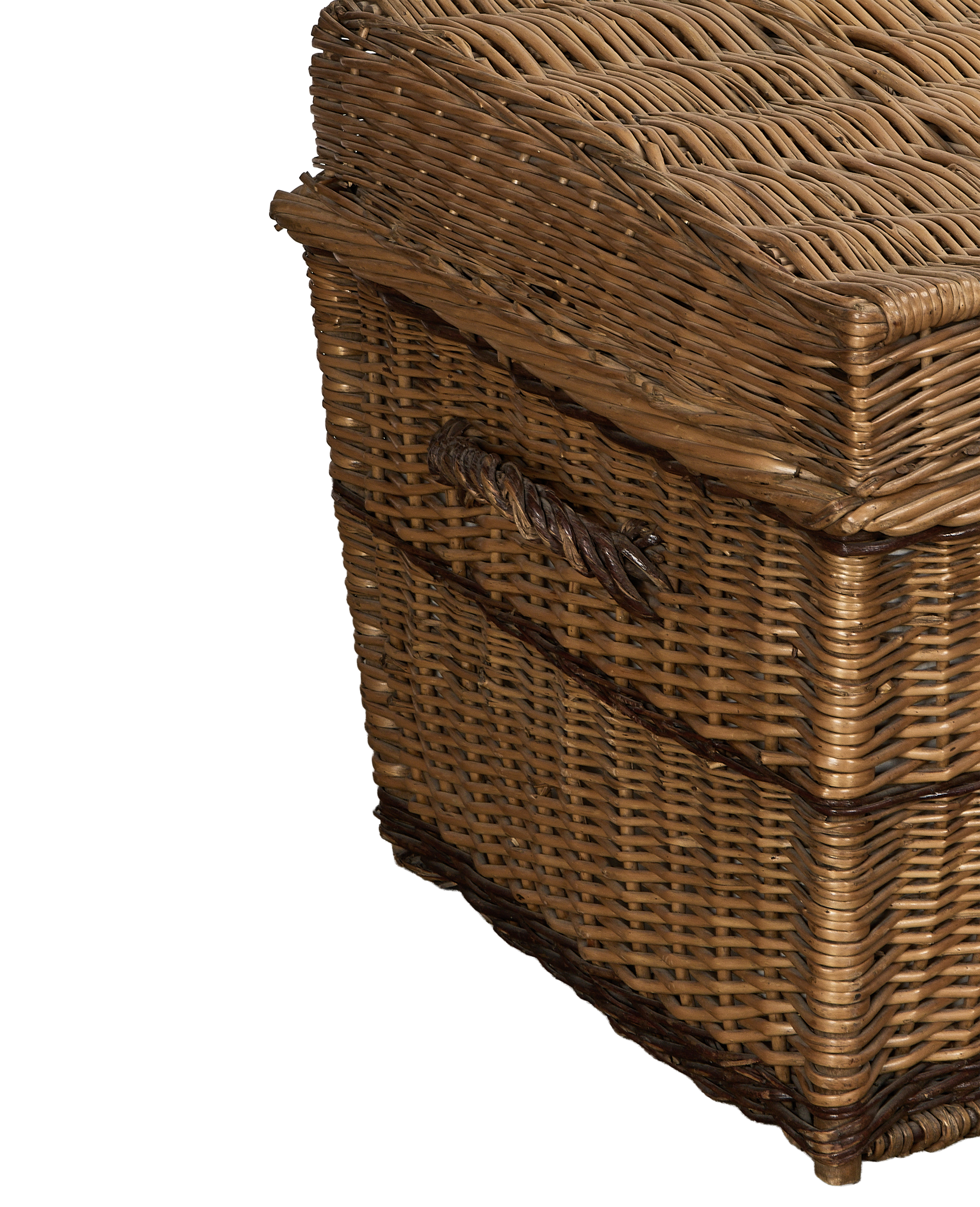 Vintage wicker chest, angled side view, showcasing the woven texture and twisted handle detail.