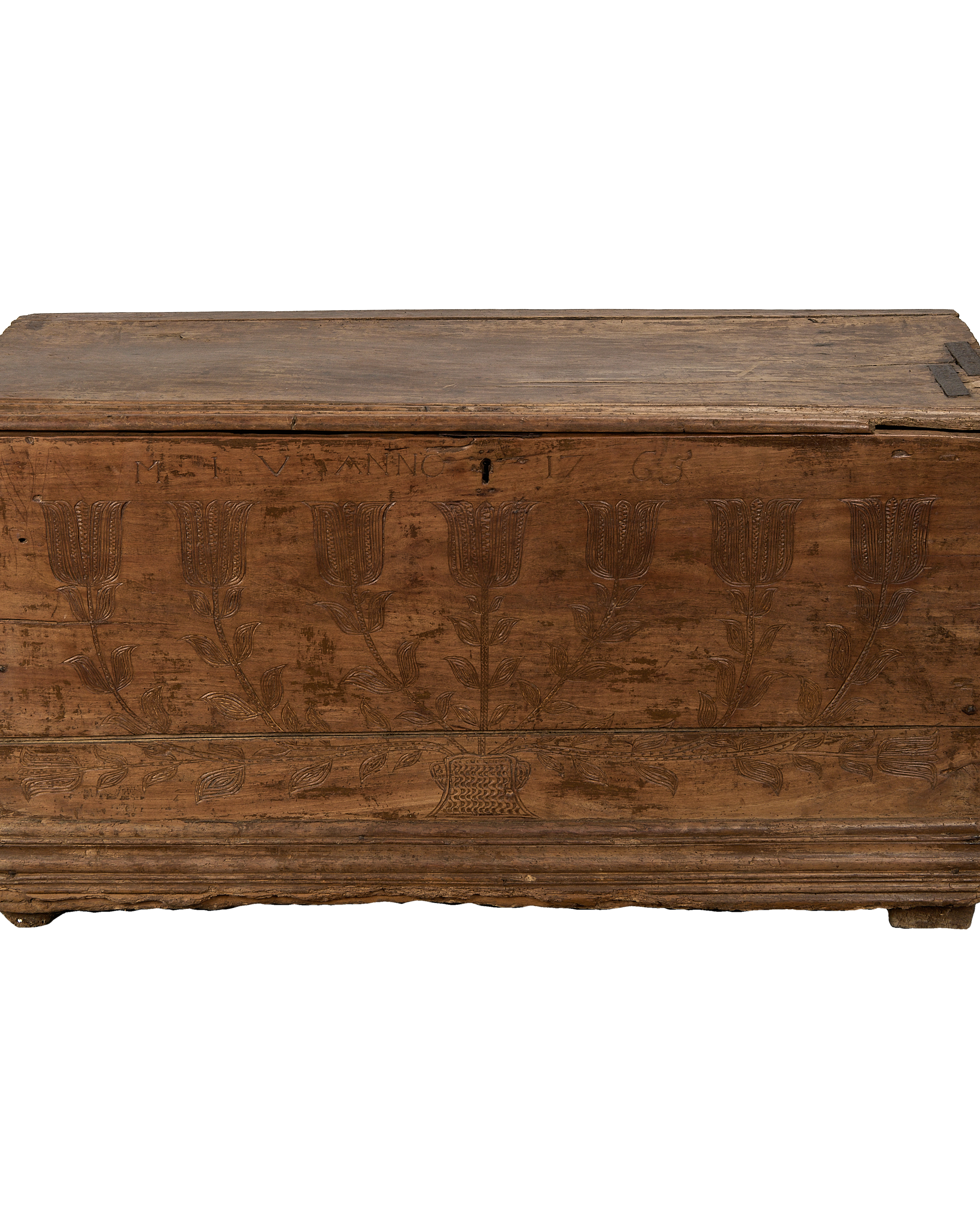 Vintage French oak chest featuring ornate hand-carved floral tulip designs, a keyhole, and distressed finish.