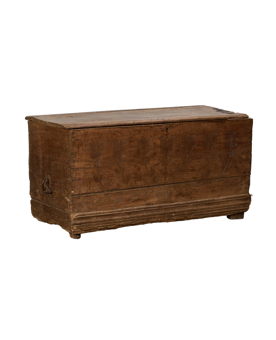 Vintage French oak chest with intricate hand-carved floral tulip designs on front panel.