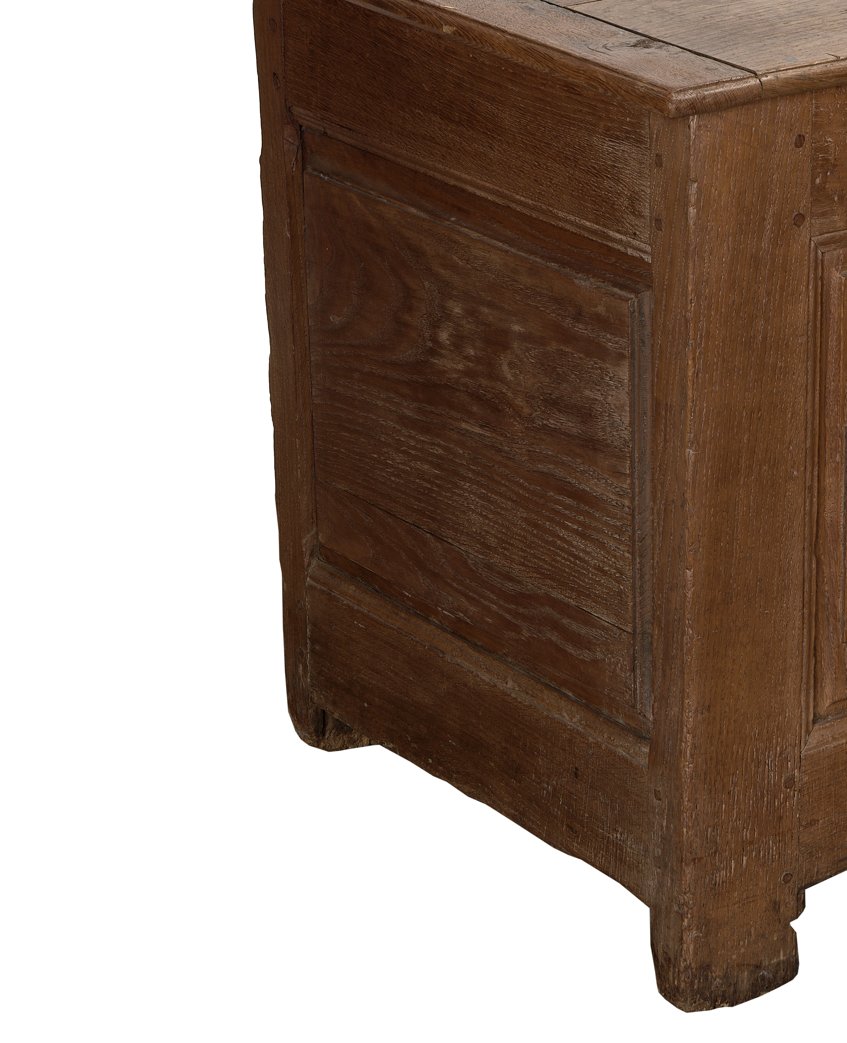 Panel detail of the vintage French oak blanket chest, showcasing the leg and base.