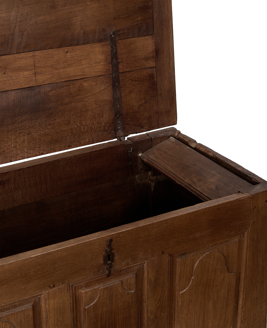 Open vintage French oak blanket chest showing hidden internal drawer and iron hinge.