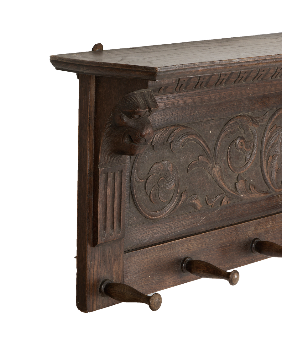 Vintage French oak hanging shelf, detail of carved grotesque mask and acanthus leaf.