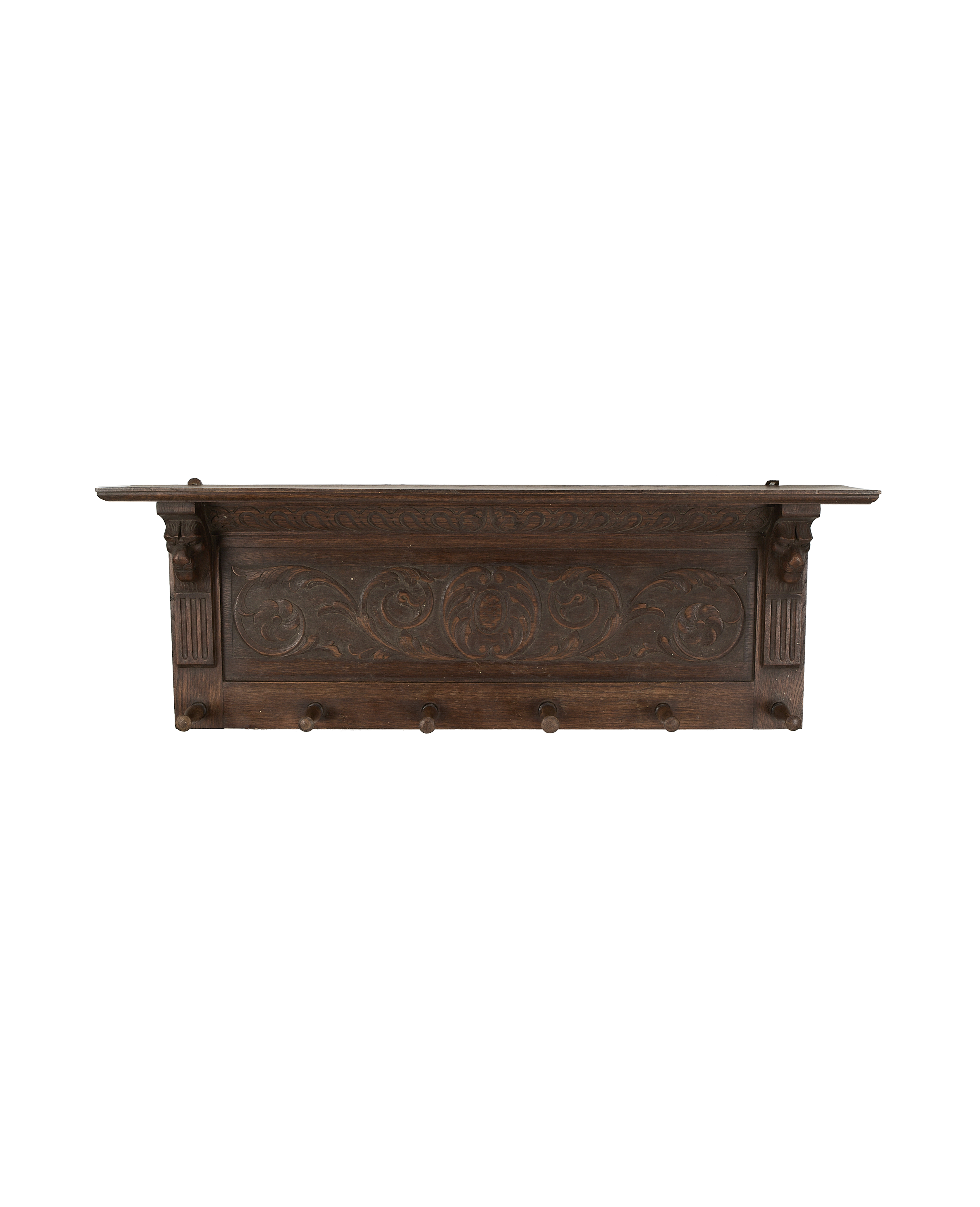 Carved oak vintage French hanging shelf with decorative scrollwork above five wooden pegs.