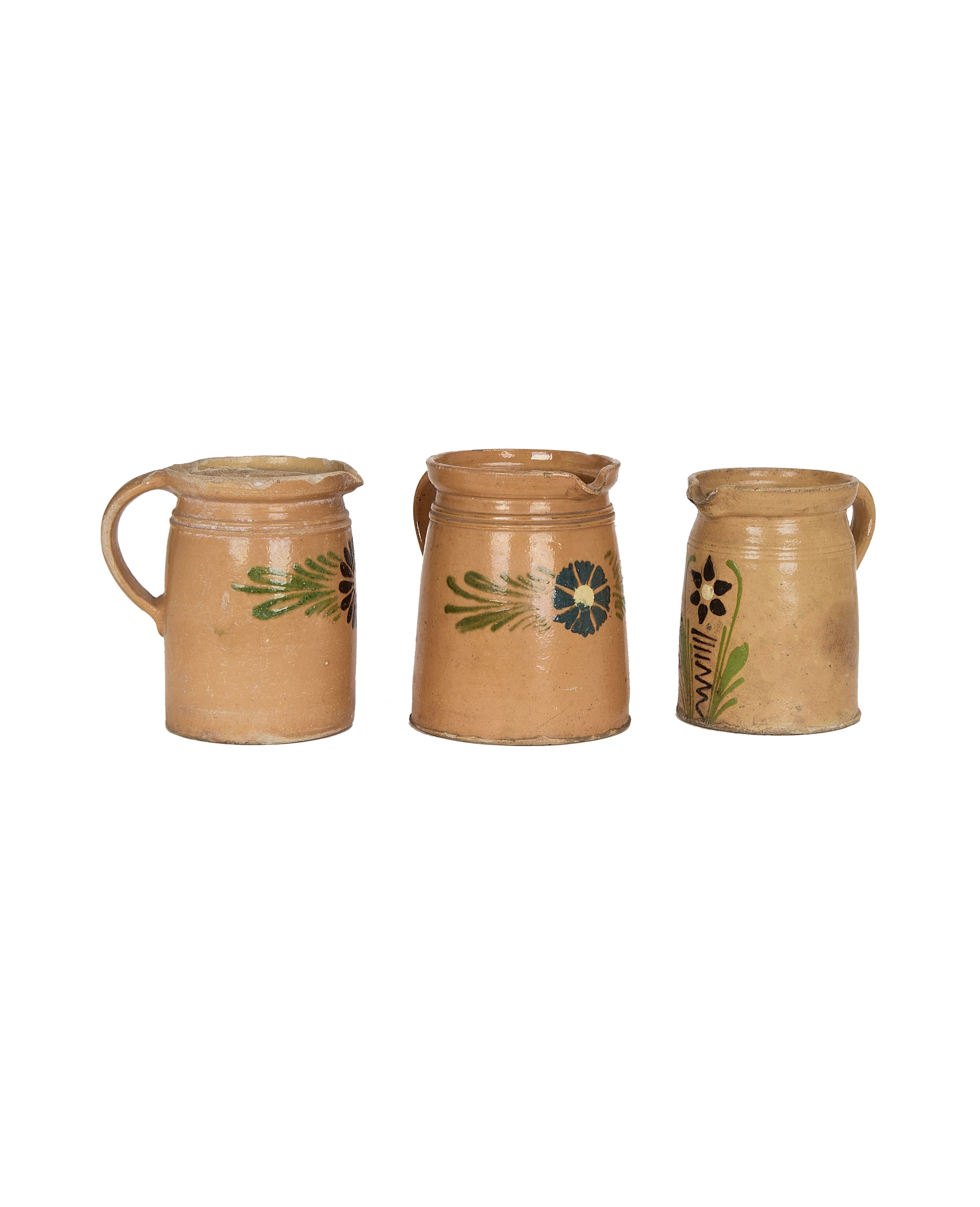 Three vintage French stoneware pitchers, mustard Alsace glaze with unique handpainted folk art flowers.