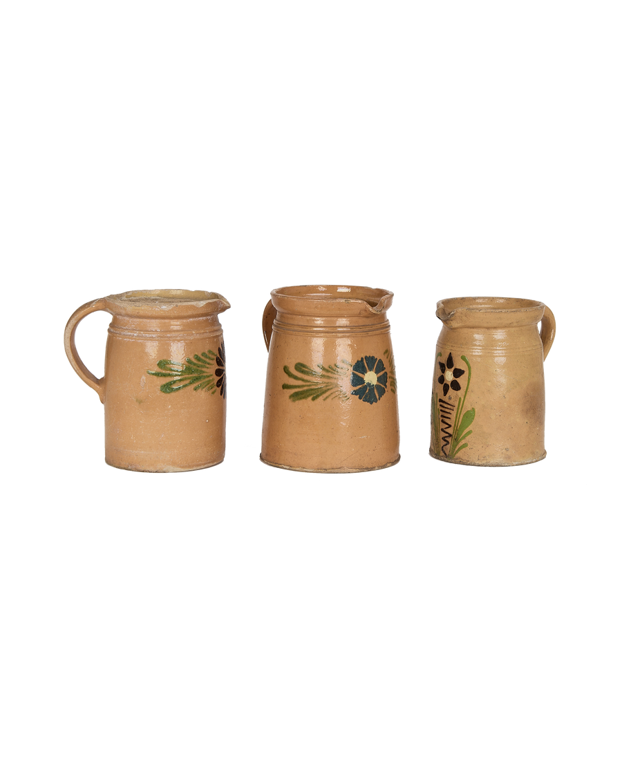 Three vintage French stoneware pitchers, mustard Alsace glaze with unique handpainted folk art flowers.