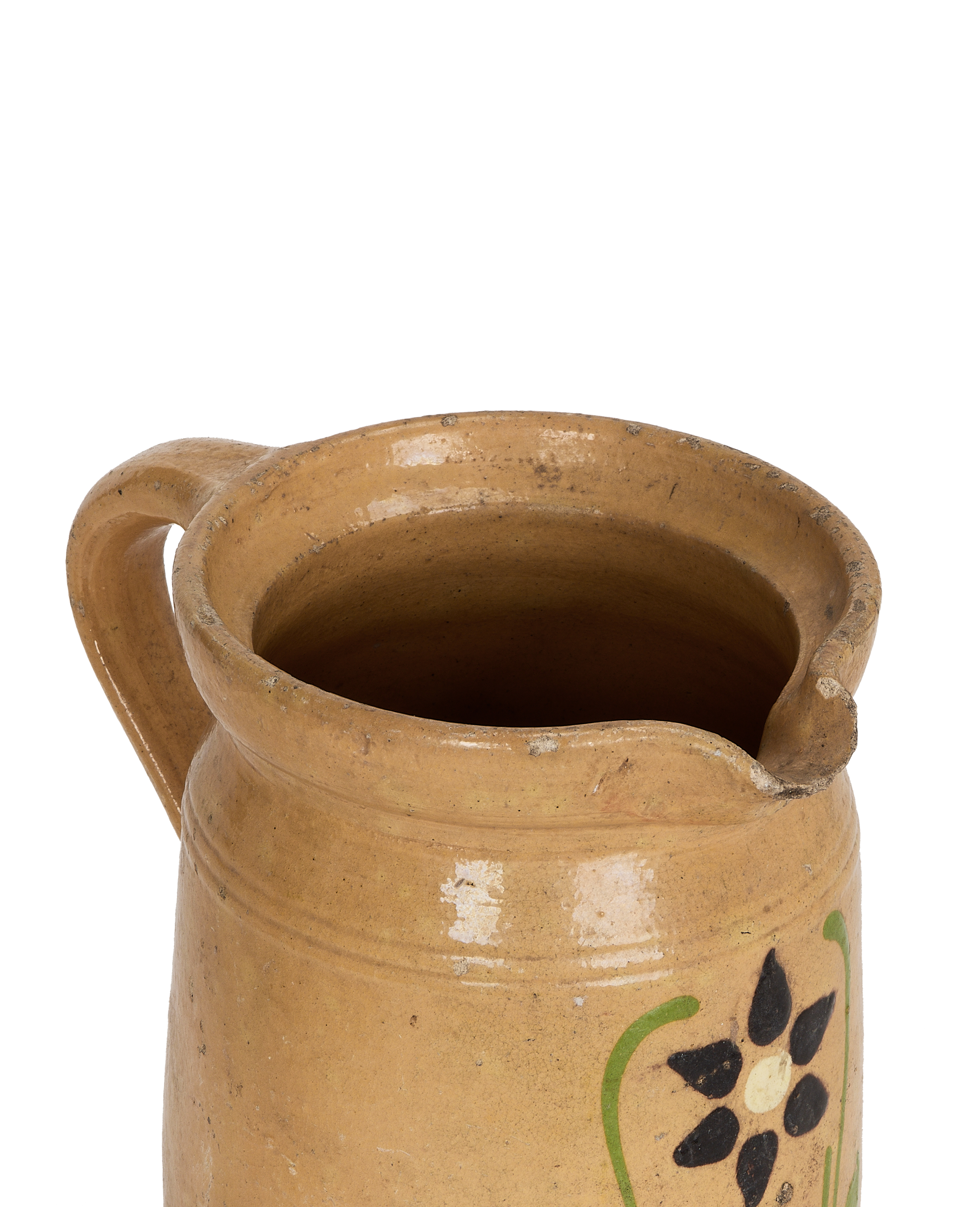 Vintage French mustard yellow Alsatian ceramic pitcher, close-up top view.